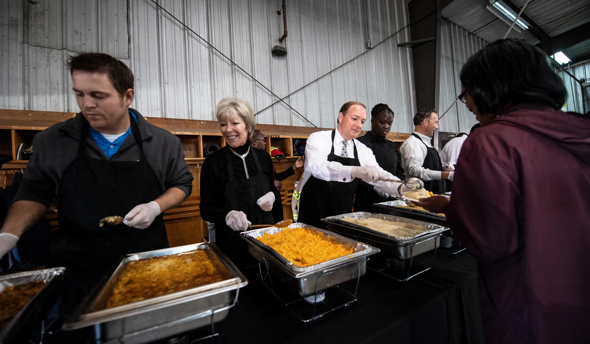 MSU President Dr. Mark Keenum serves Thanksgiving lunch to firefighters and other city officials at Fire Station one.