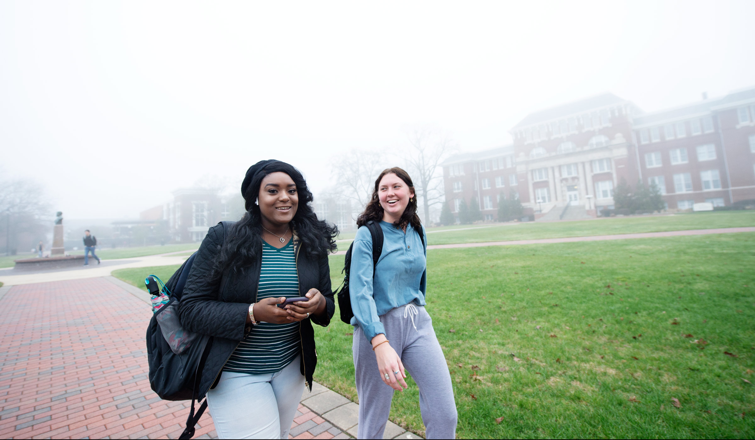 With a foggy Drill Field behind them, students Jaslynn Ware and Bethany Deuel walk to French class together.
