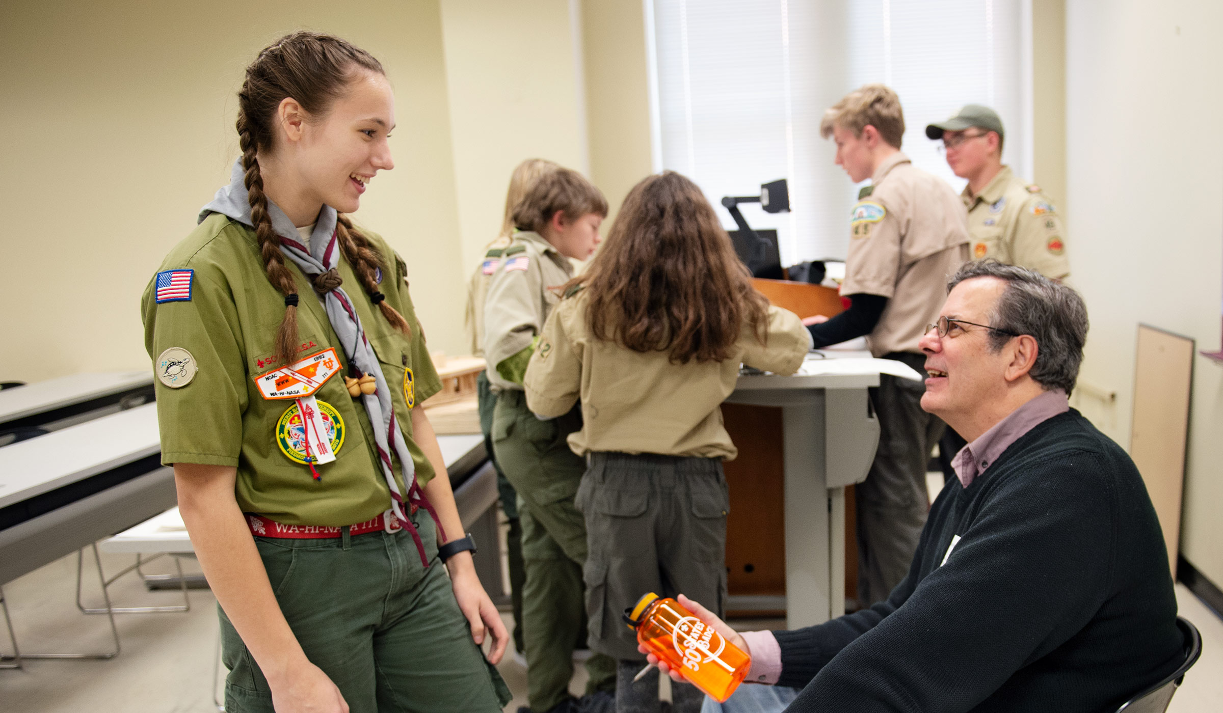 BSA Scout Taylor Bell presents a water bottle to MSU Architecture Professor Richard Chenoweth, commemorating her 28th state to complete a merit badge in.