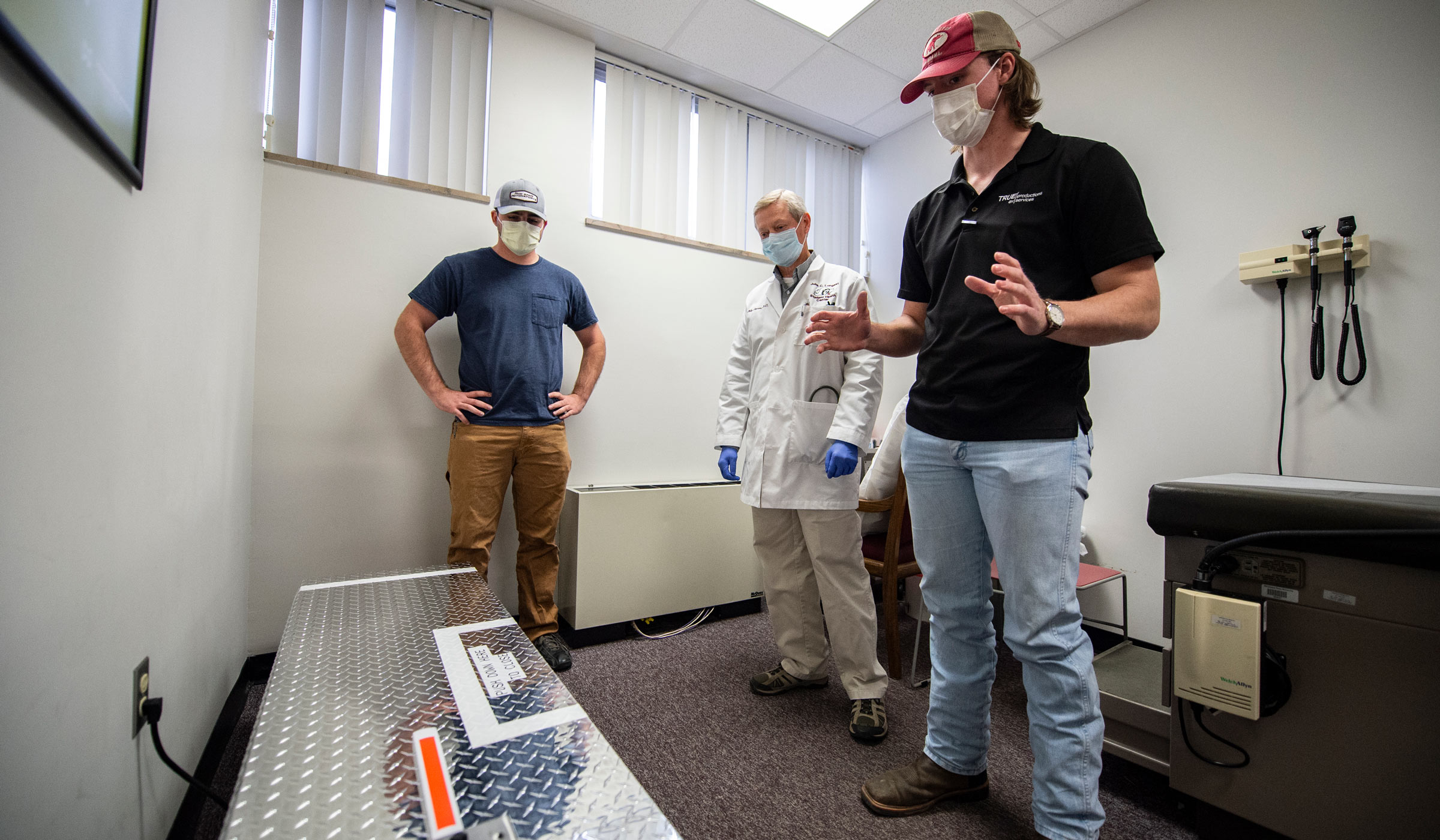 Dr. Philip Pearson, a staff physician for MSU’s Longest Health Center, gets a detailed description of the facility’s new face mask sanitizer from mechanical engineering student Ryden Smith. 