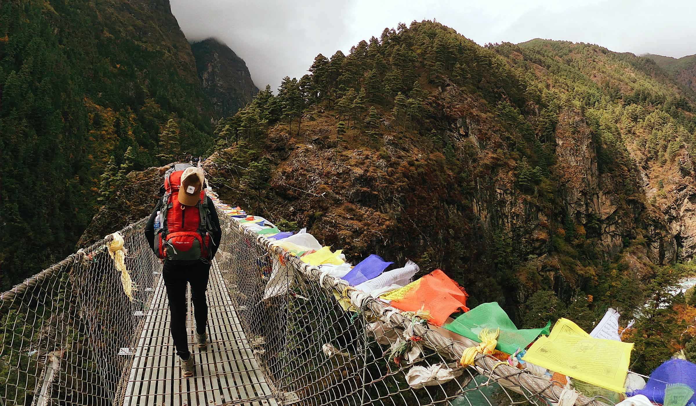 Hannah Austin walks across a remote bridge.