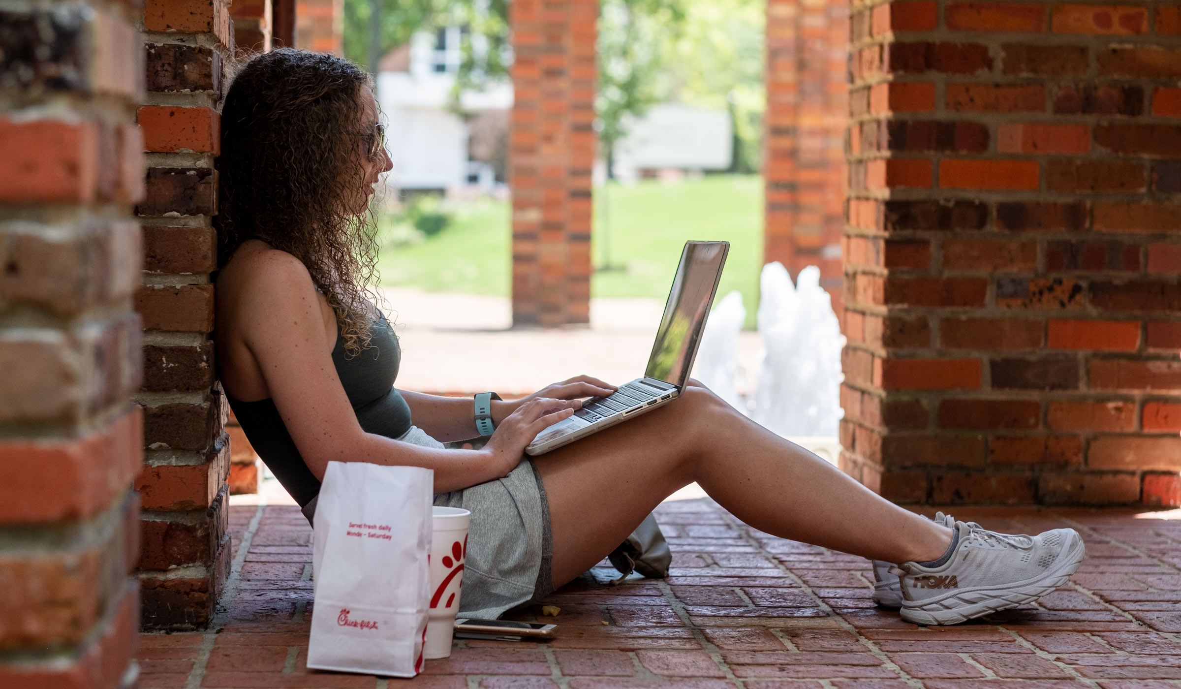 Elementary Education major Alex Mogenson readies to stream her summer class by the Chapel fountain.