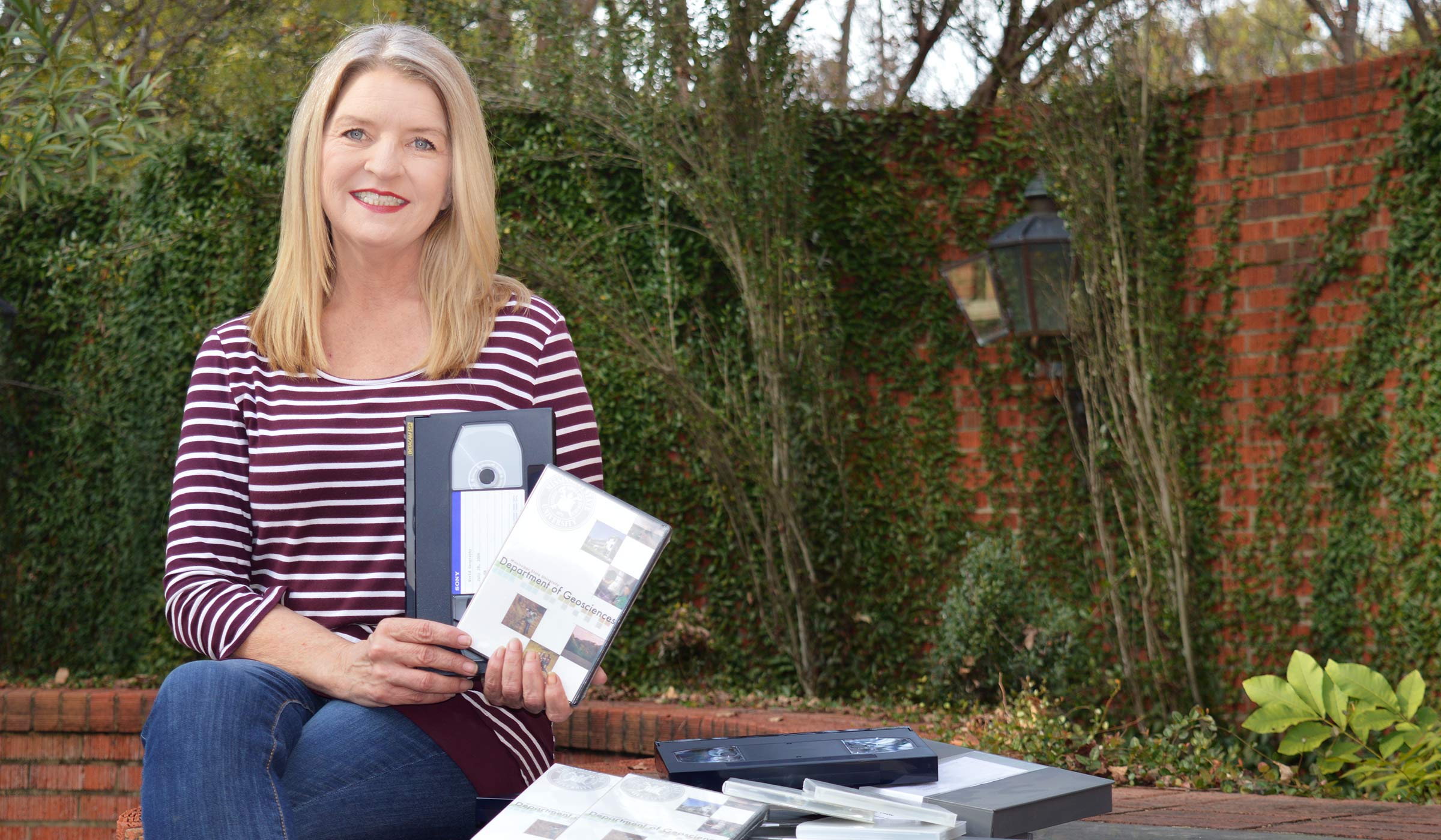 Joy Bailey, pictured holding old VCR tapes
