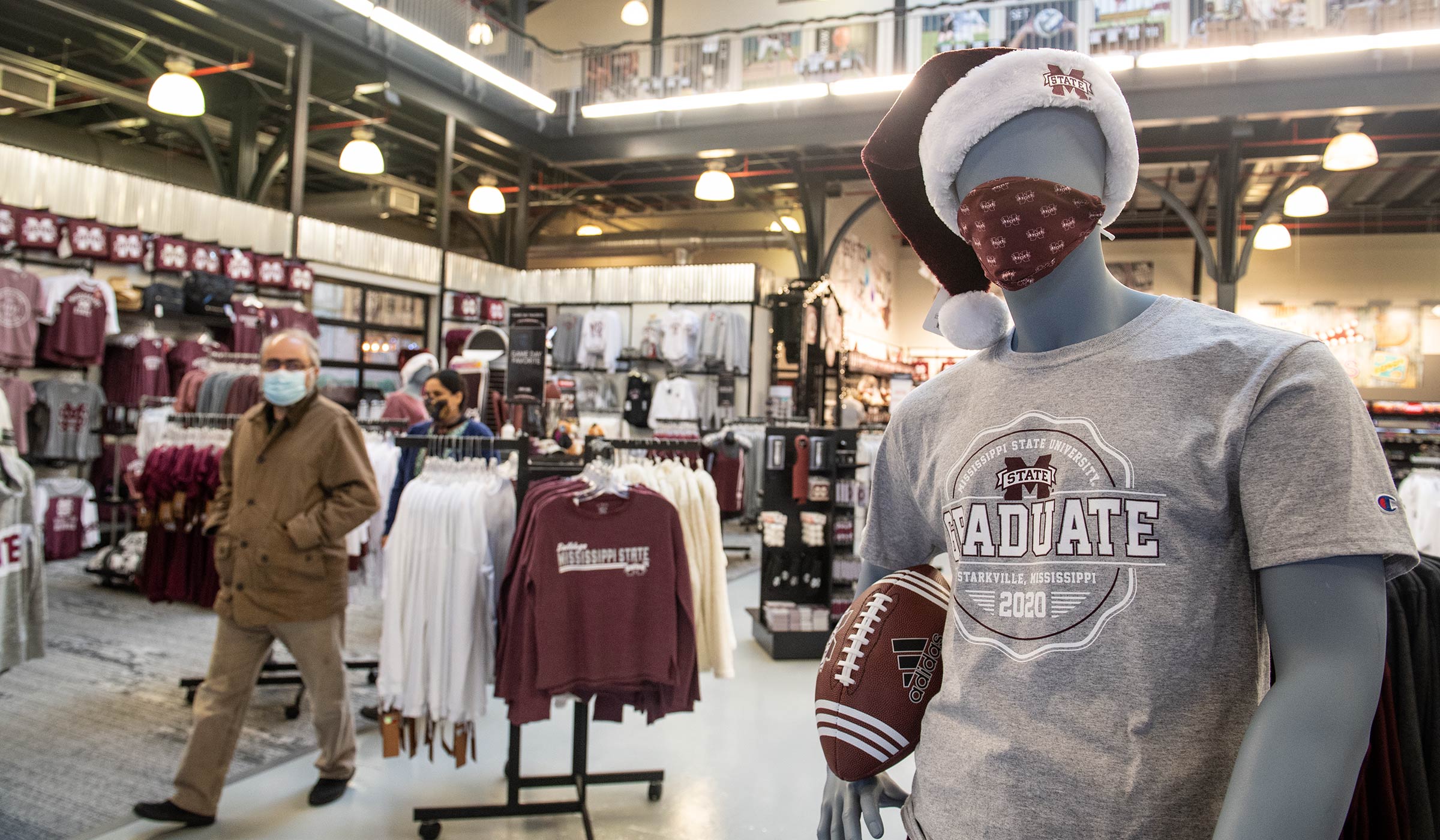 Barnes &amp; Noble mannequin wearing Santa hat and MSU face mask.
