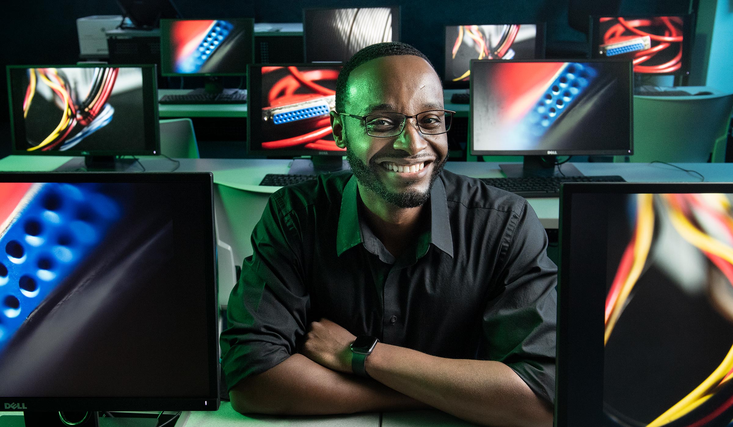 Marq Greenlee, pictured in a room full of desktop computers.