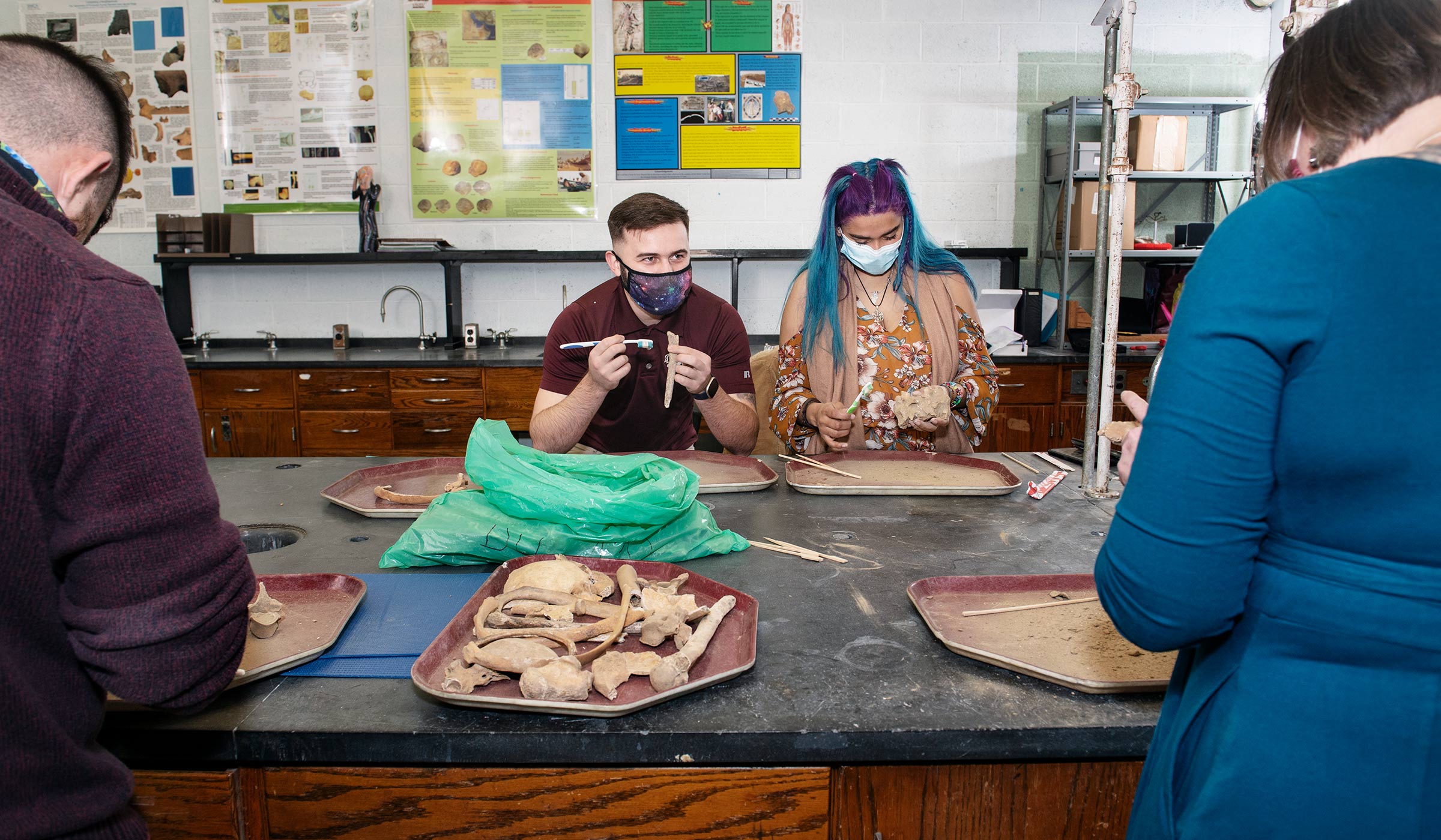 Students work in an Anthropology lab in Etheridge, cleaning a shipment of bones from Croatia, readying for education and research.