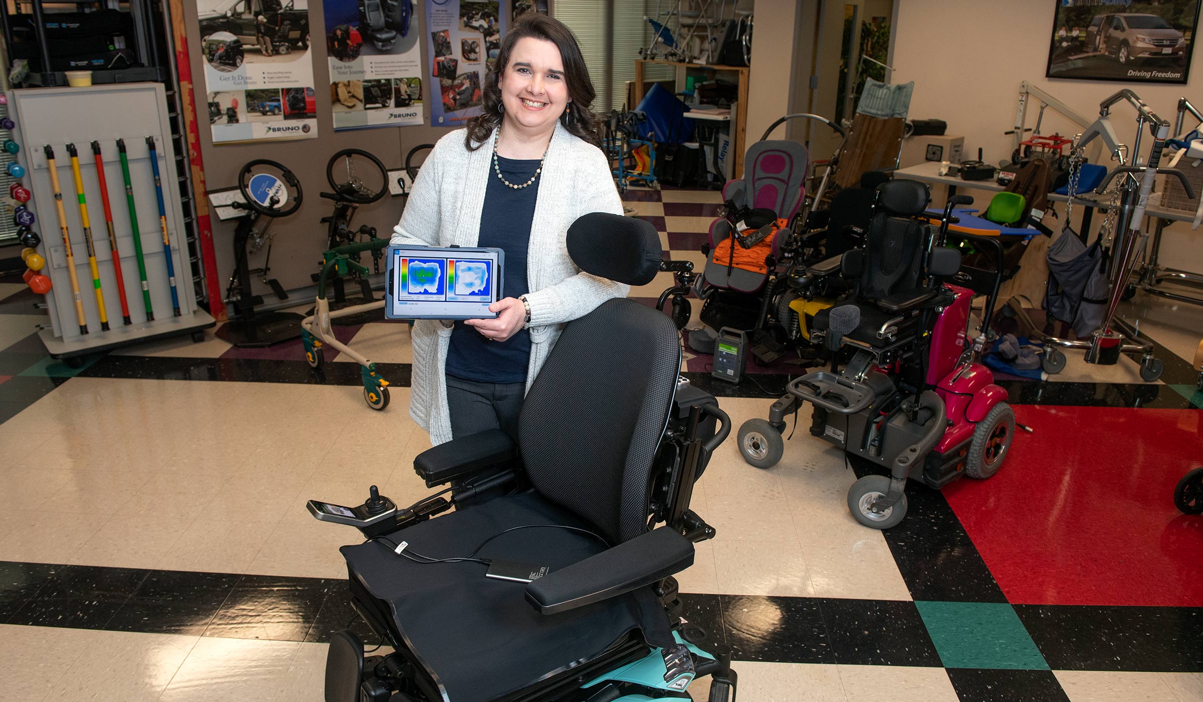 Rebecca Mathis, pictured holding a tablet loaded with specialized software at MSU's T.K. Martin Center for Technology and Disability.