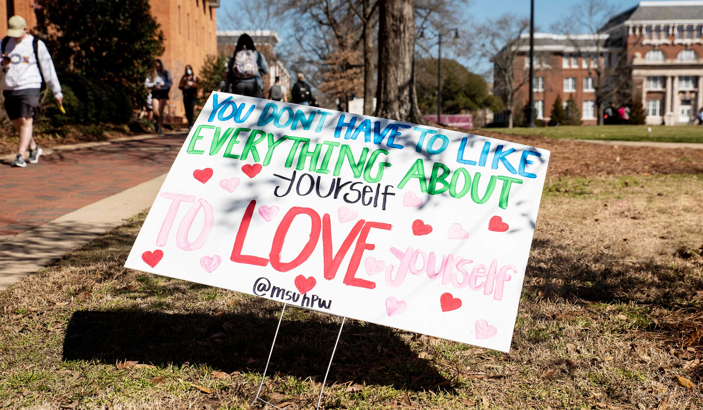 A sign on the Drill Field reminds passerbys &quot;You Don&#039;t Have to Like Everything About Yourself to Love Yourself.&quot;