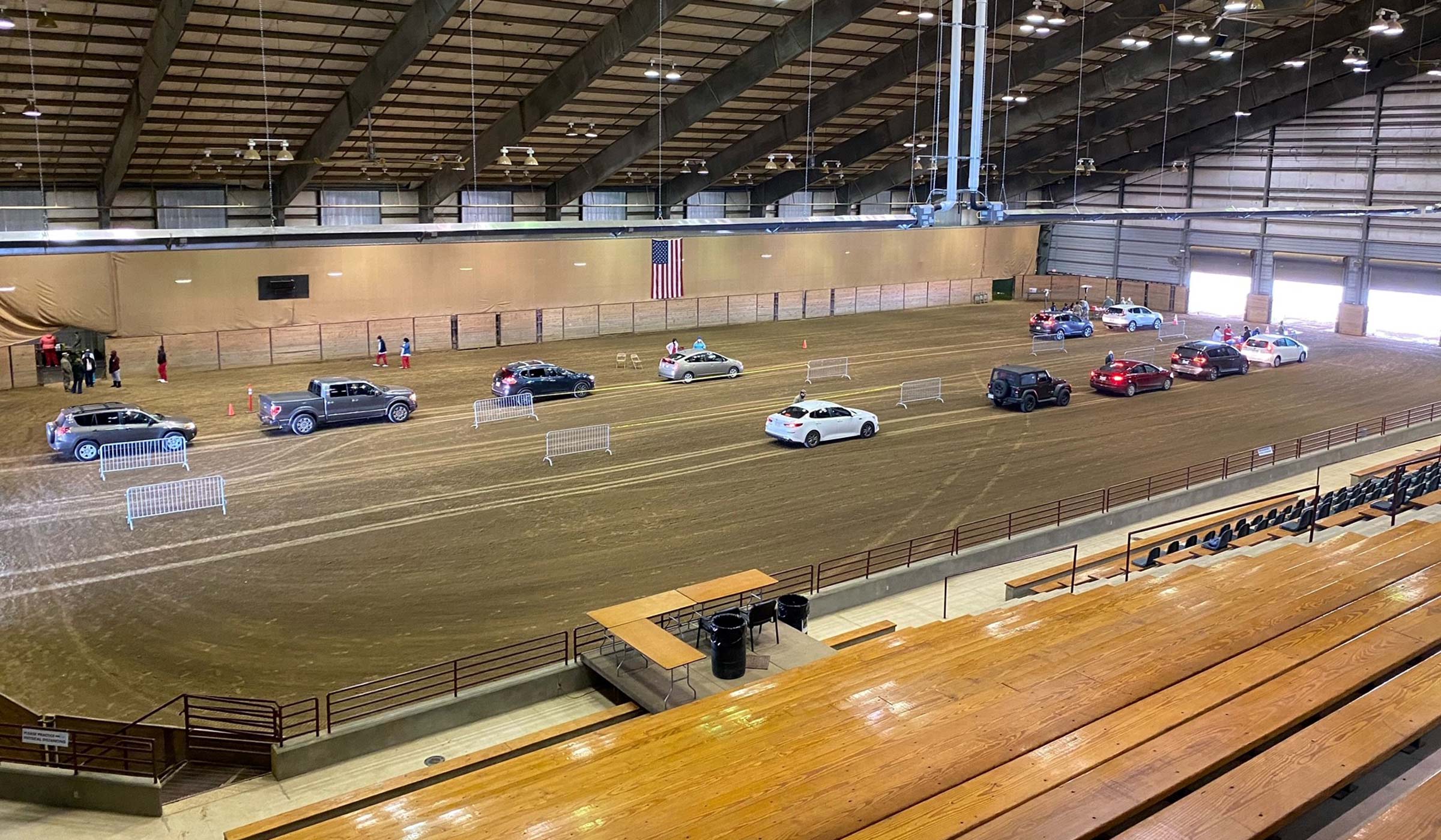 Lines of cars cross the interior of the Horse Park exhibition space, taking their turns for the Covid-19 vaccination.