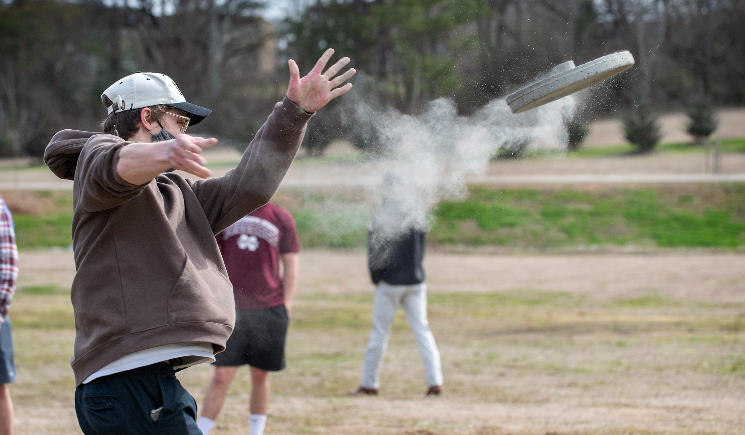 As junior architecture student Mic Wilkins throws his team&#039;s concrete frisbee, a trail of dust follows the spinning disk.