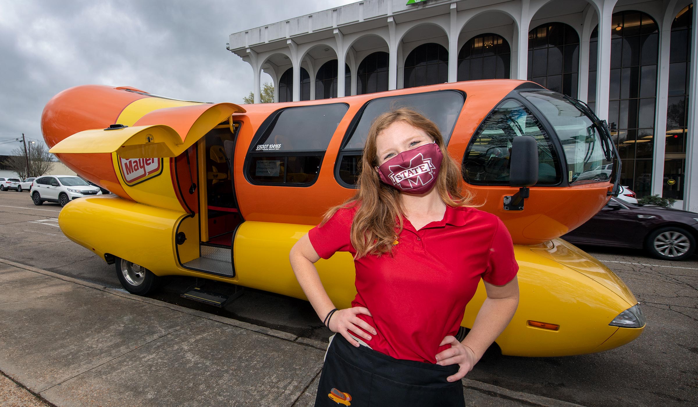 Broadcasting alum Maggie Thomas poses in front of the Oscar Meyer Weinermobile she drove to Starkville&#039;s Main Street.