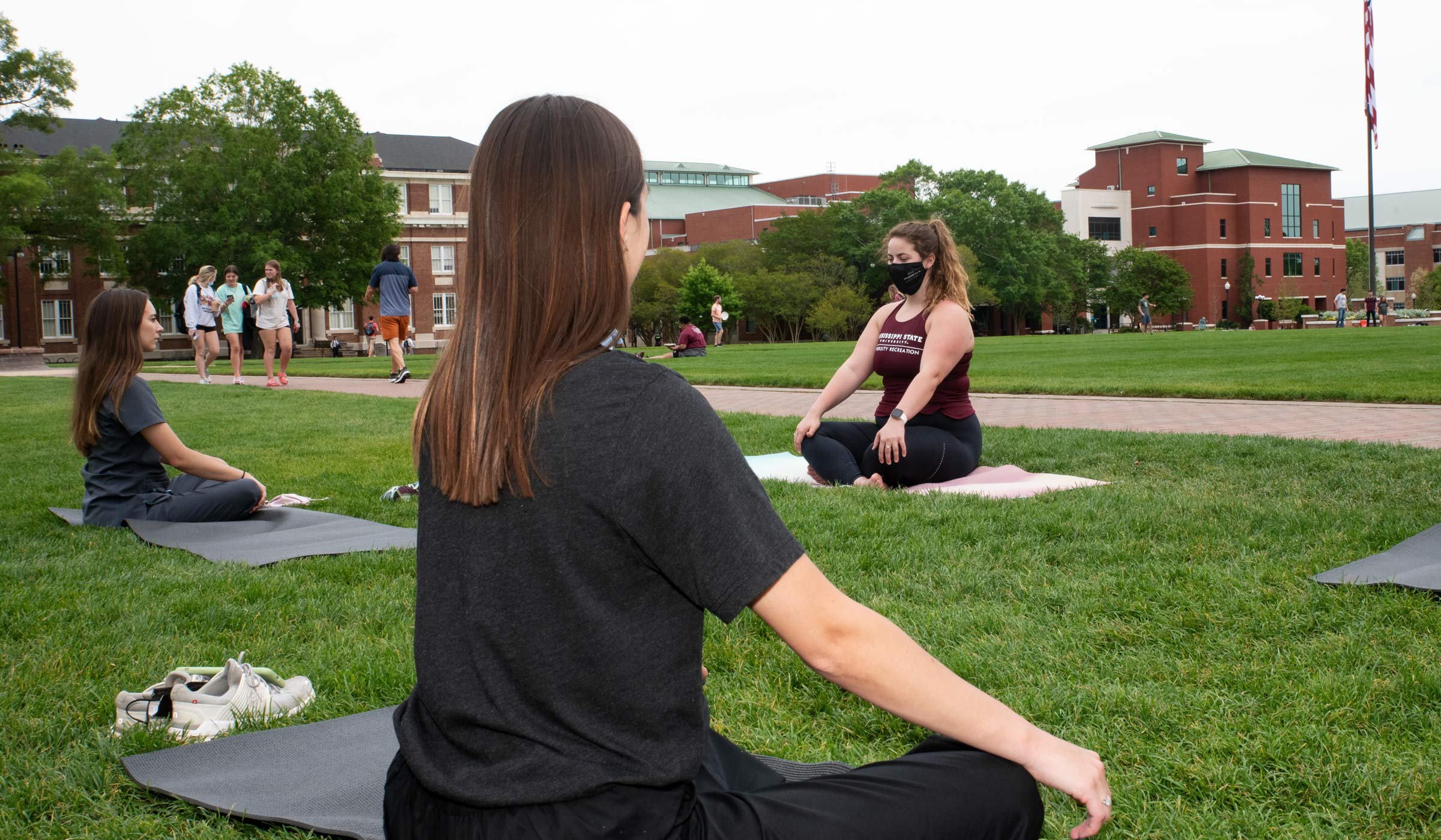 Jolie Kavanaugh instructs a yoga class during the Self-Care Fair  held on the Drill Field  (photo by Jarvis Mace / © Mississippi State University)