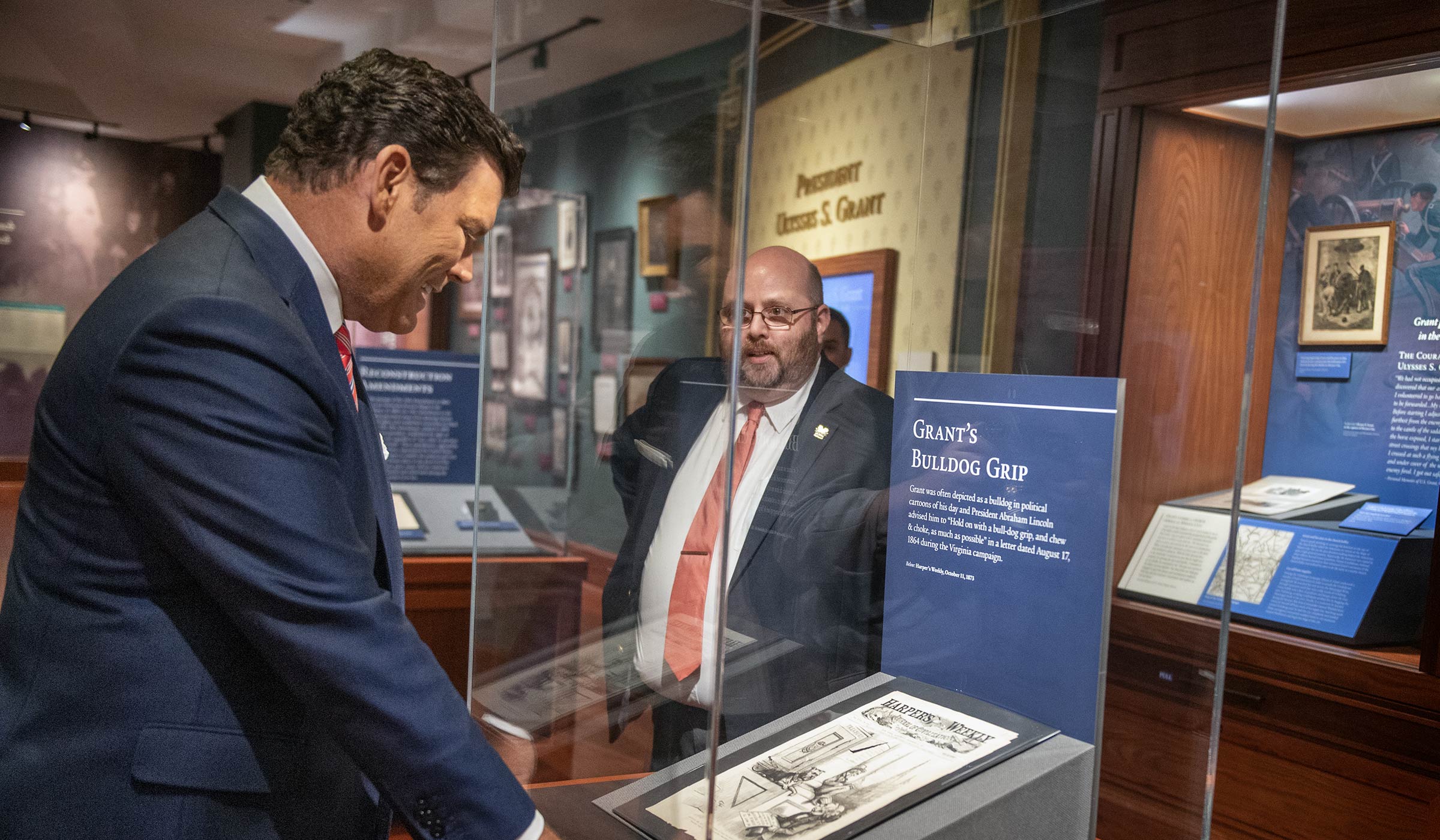 Bret Baier looks into a Grant Presidential Library case while Ryan Semmes explains the &quot;Bulldog Grip&quot; exhibit to him.