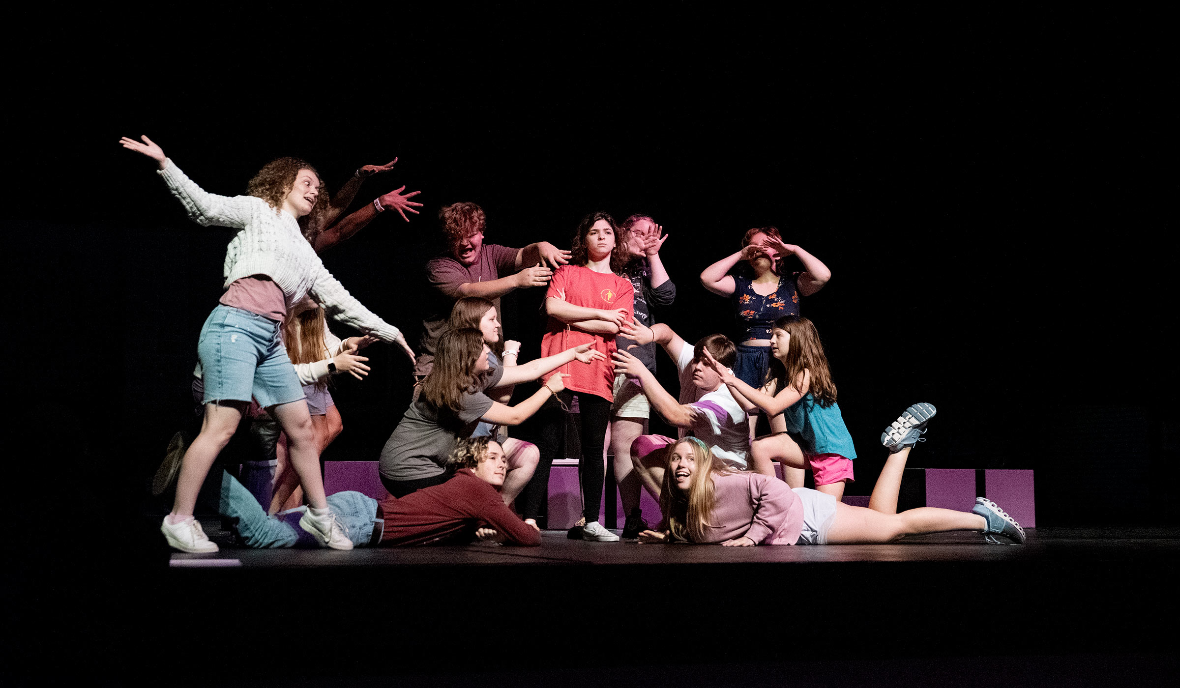High school students posed on stage during rehearsal of musical