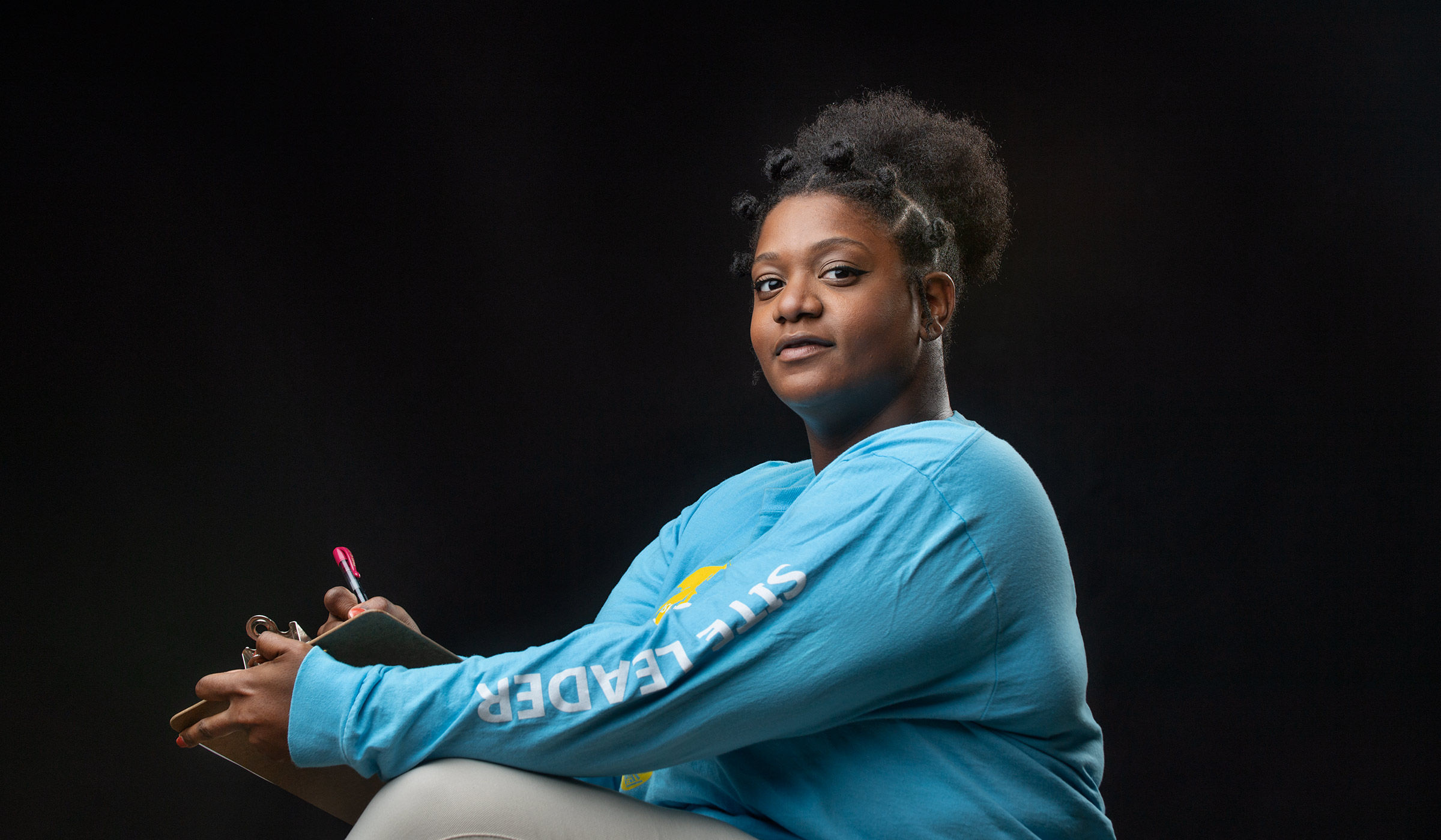 Alexis Wallace looks at the camera in front of a black background