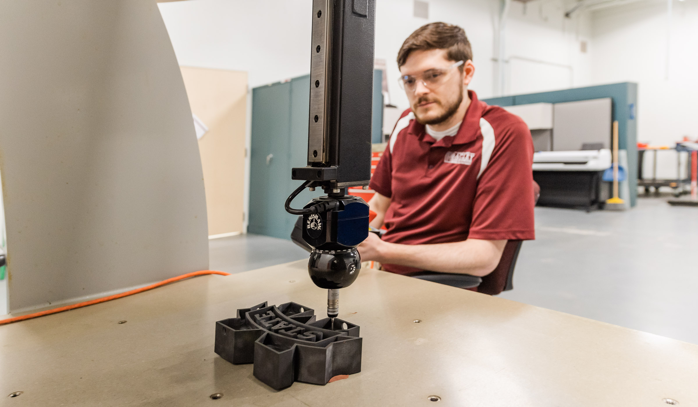 Research Engineer scanning Mississippi State Emblem