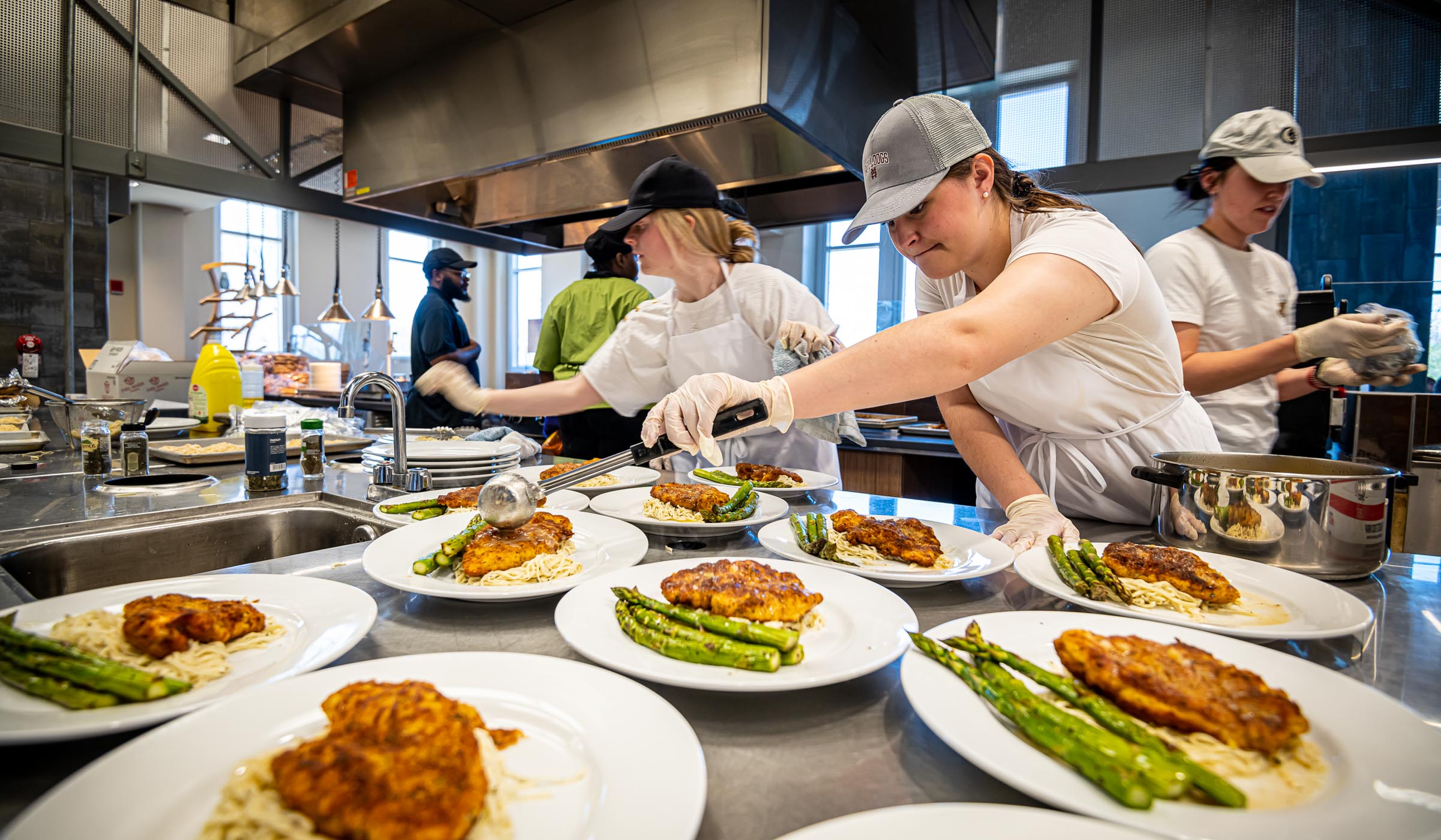 Students preparing food in commercial kitchen