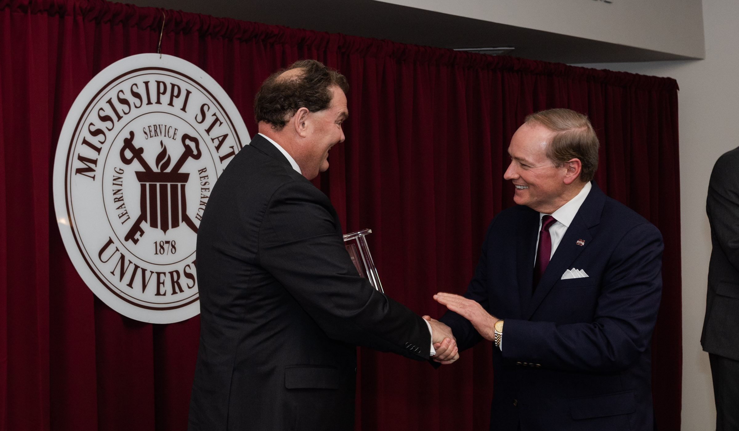 Randy J. Cleveland accepting Alumni of the Year award from President Keenum