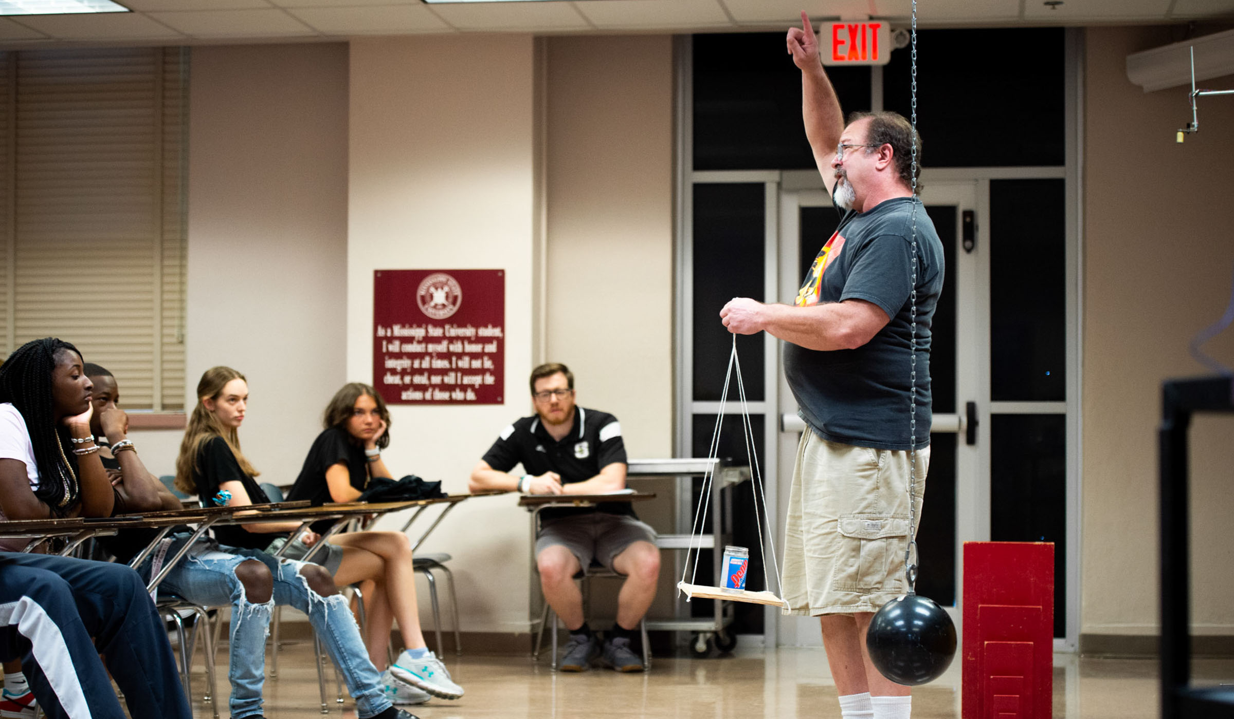 Dr. Jeff Winger, Professor in MSU&#039;s Department of Physics &amp; Astronomy, conducts a physics exercise to a group of high school student