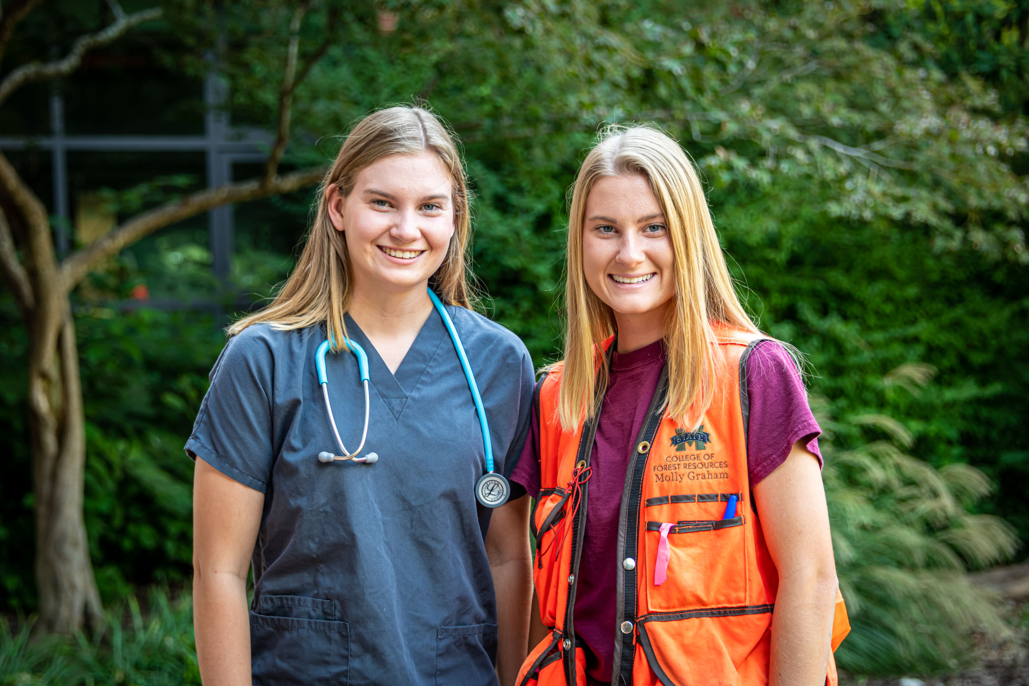 Mattie and Molly Graham, pictured in front of trees outdoors.