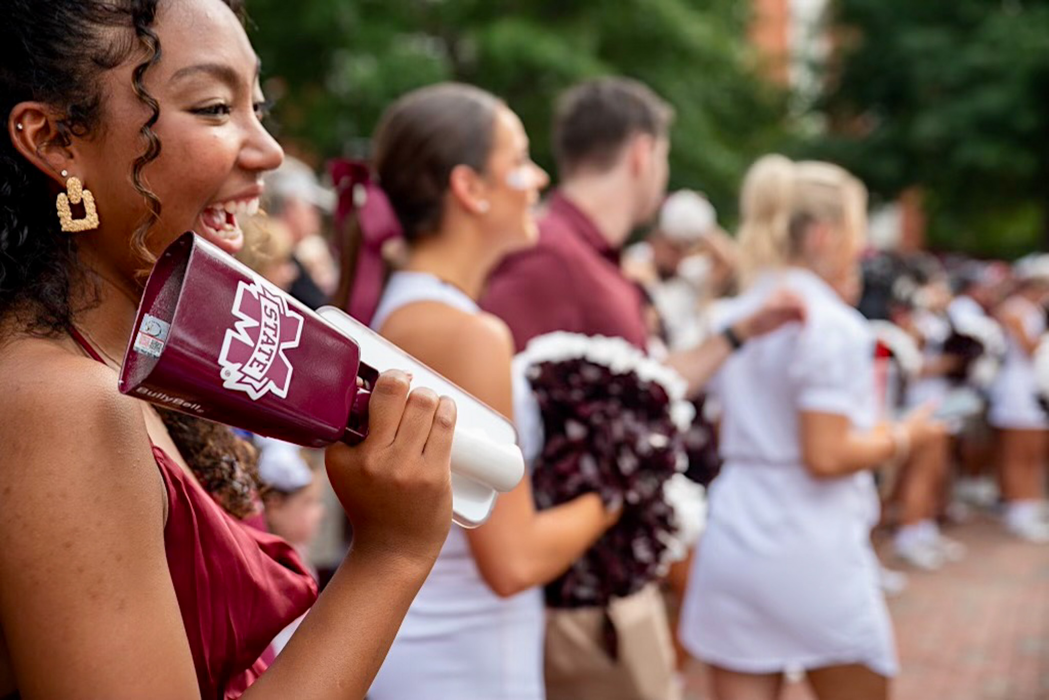 Excited fans gather in the Junction with cowbells and State spirit