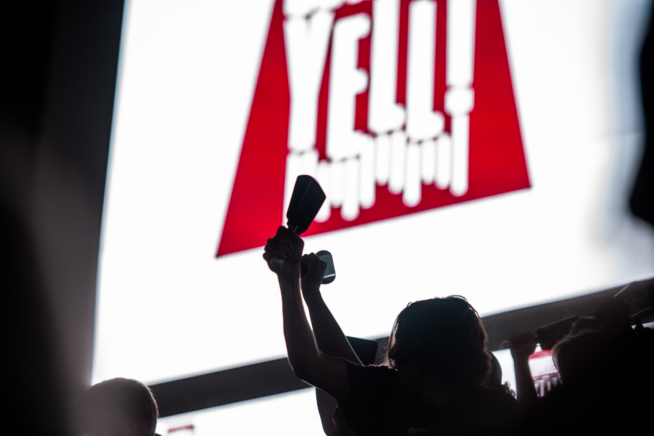 Cowbells held high silhouette against Davis Wade Stadium&#039;s jumbotron at the 2022 Cowbell Yell Pep Rally