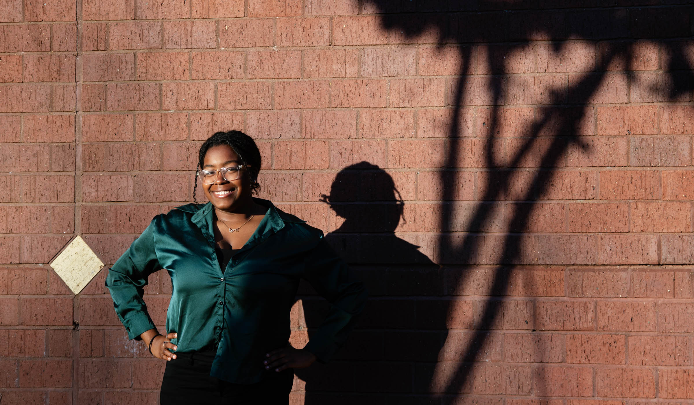 Anita Isaac, pictured casting a shadow on a brick wall.