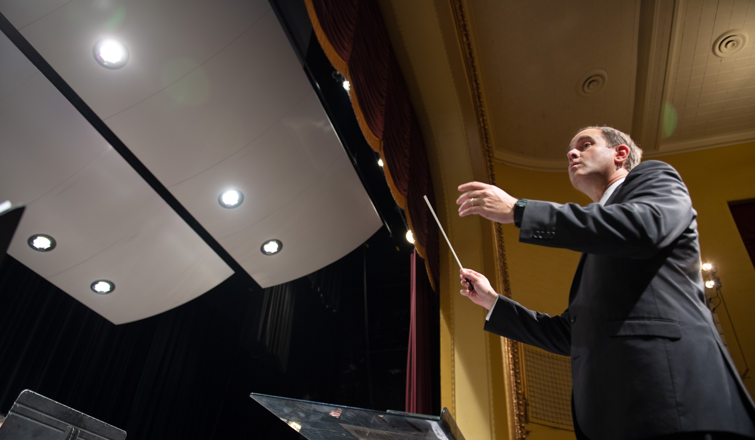 Associate Band Director, Craig Aarhus conducts the Wind Ensemble in Bettersworth Hall.