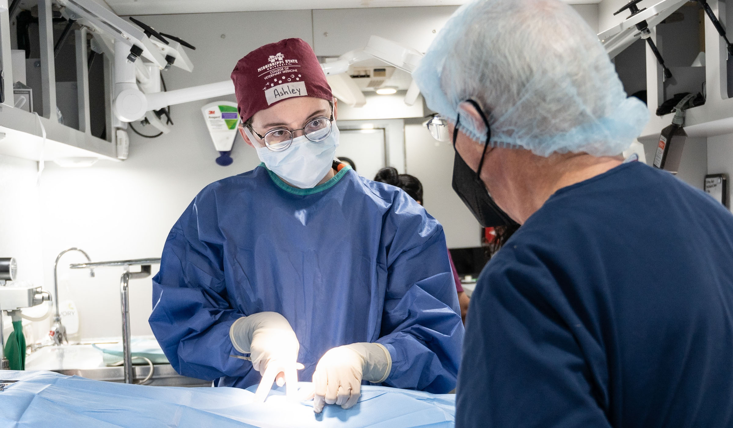 CVM student Ashley Smith conducts 500th surgery in mobile veterinary unit, with Dr. Phil Busby supervising.