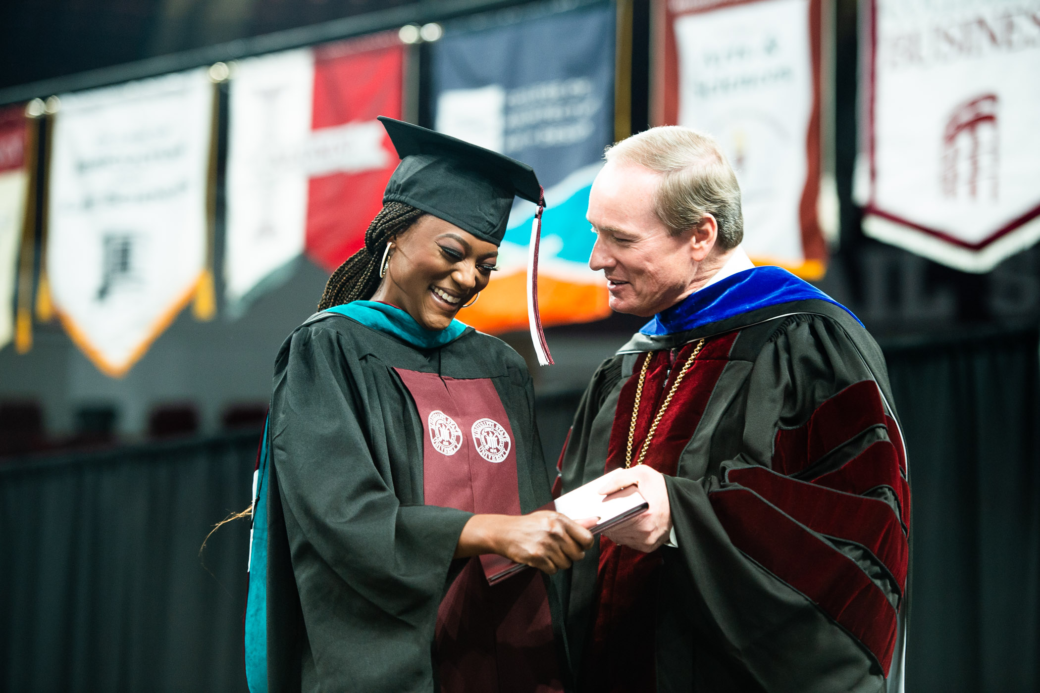 MSU Graduate NaToya Sanders crosses the stage to receive her diploma from MSU President Mark E. Keenum
