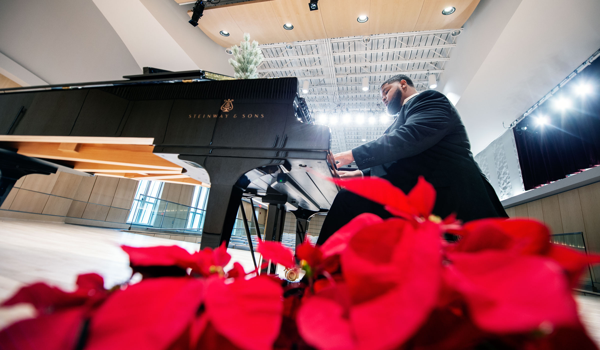 Desmond Henderson, pictured playing a Steinway piano in MSU's new Music Building
