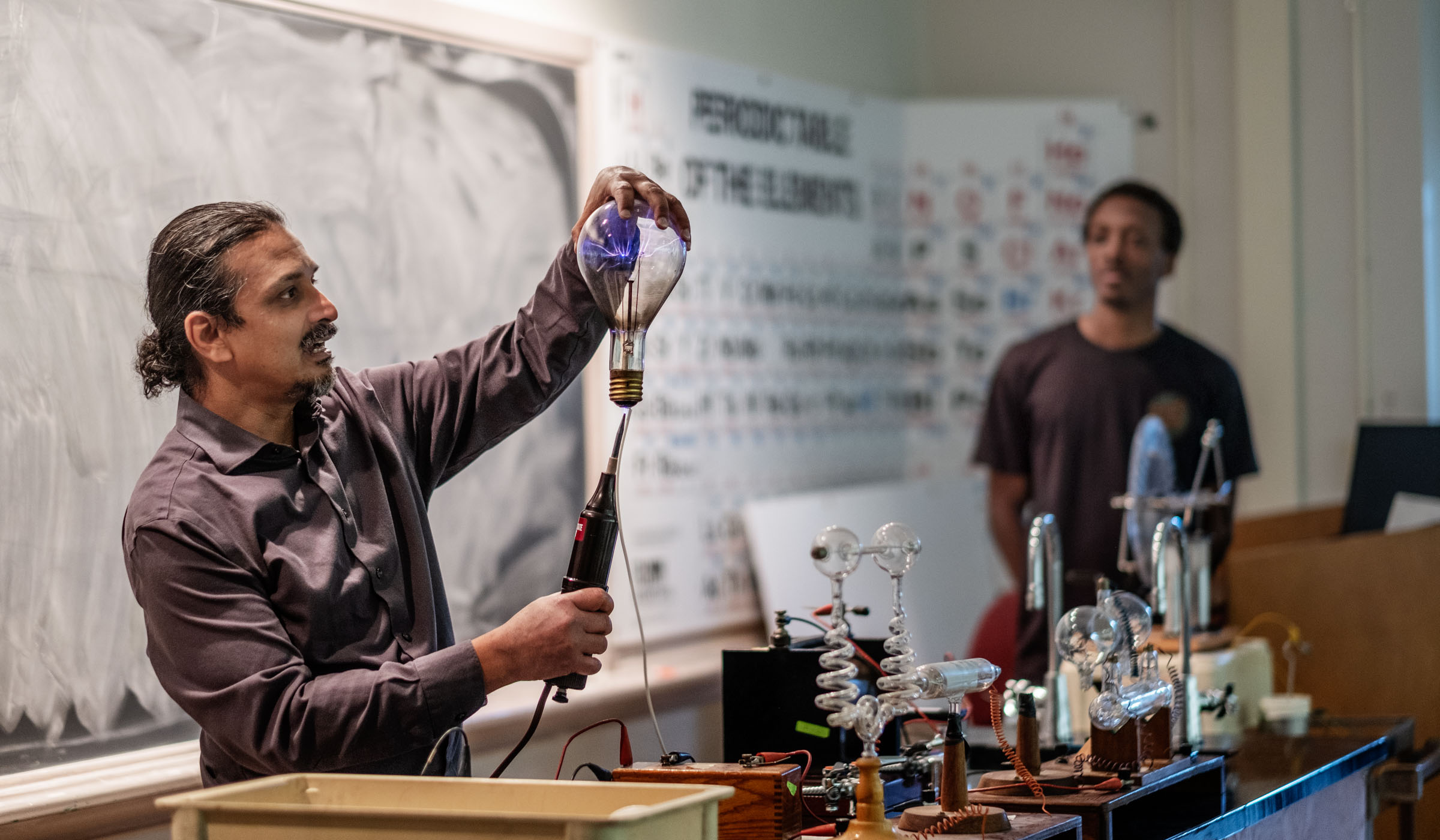 Physics professor Dipangkar Dutta demonstrates the conductivity of electricty, using a plasma lightbulb.