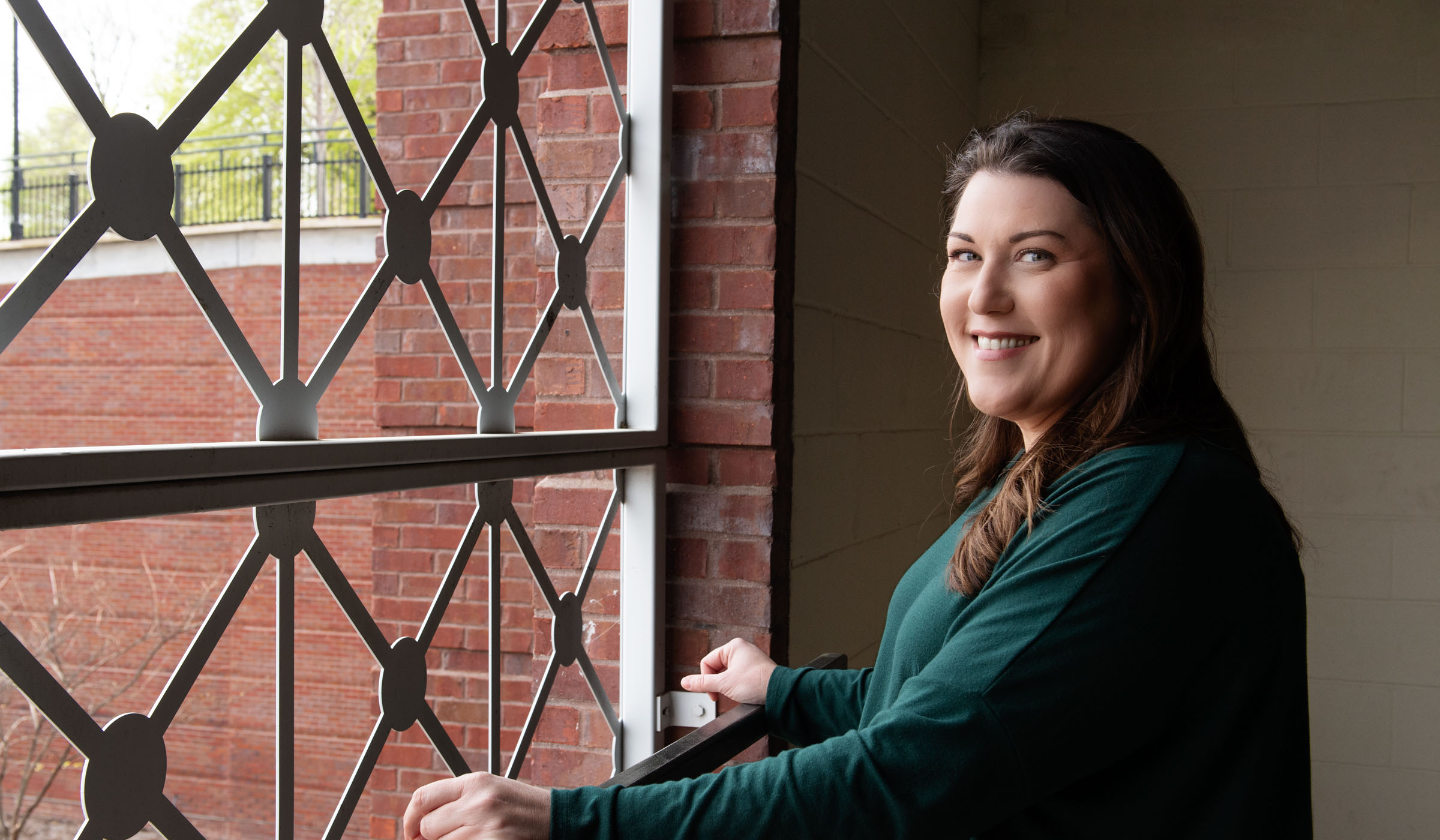 Emily Cain, pictured in front of a window on the MSU campus