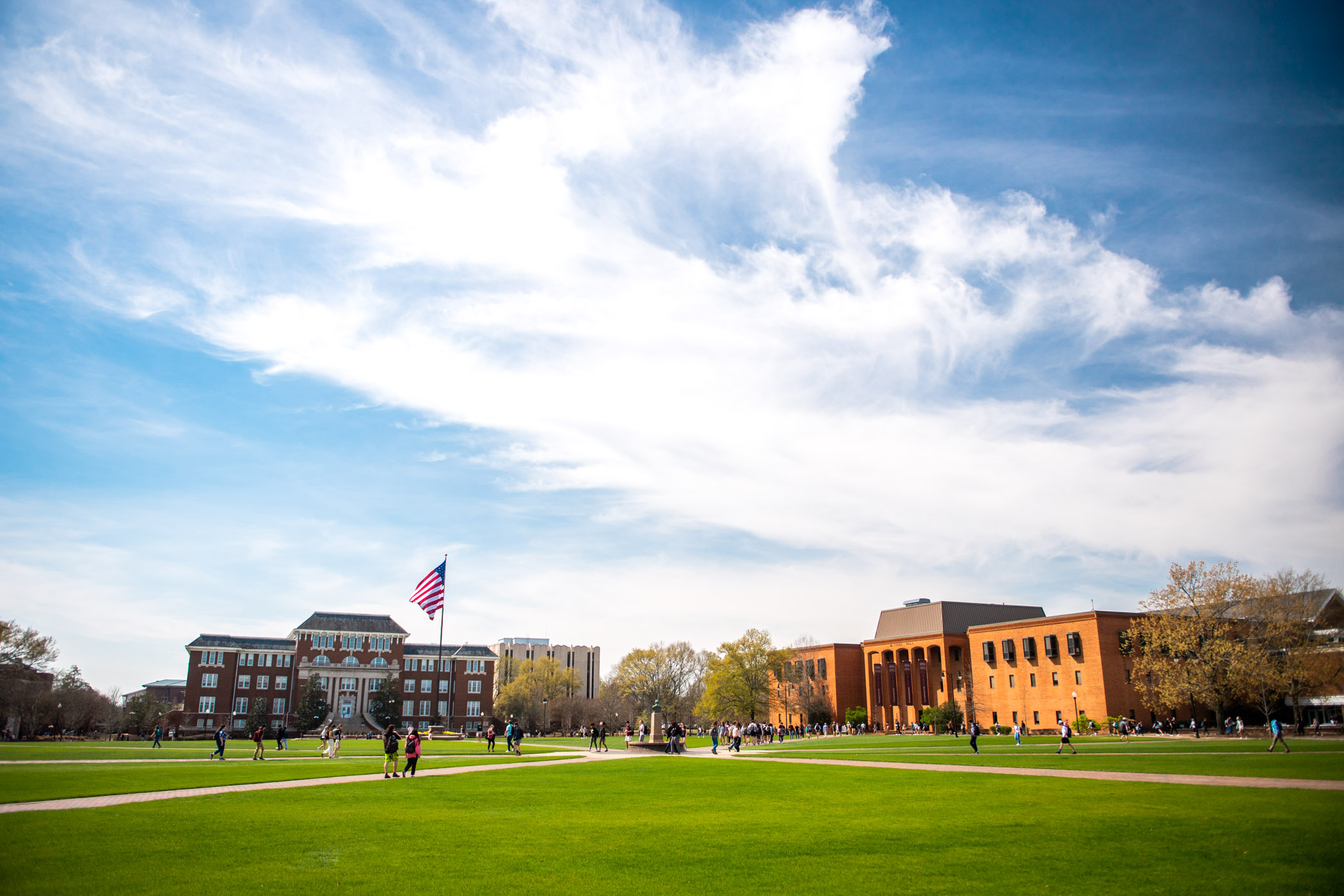 Students cross the Dill Field during a sunny class exchange.