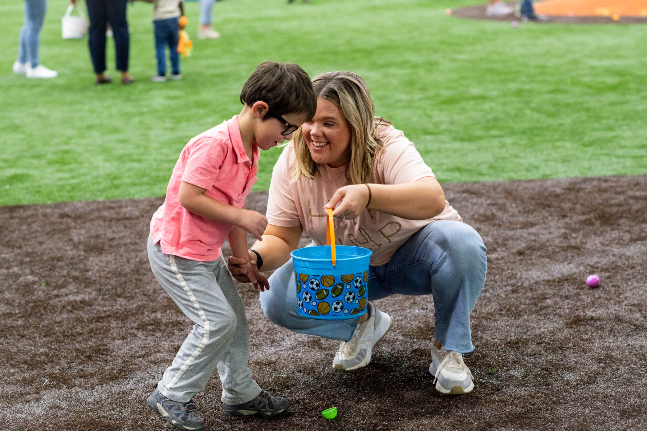 T.K. Martin Center for Technology and Disability Lead Teacher, McKenzie Foster, assists a student with collecting hidden eggs at an Easter Egg Hunt inside MSU&#039;s Palmiero Center in celebration of the upcoming spring holiday.