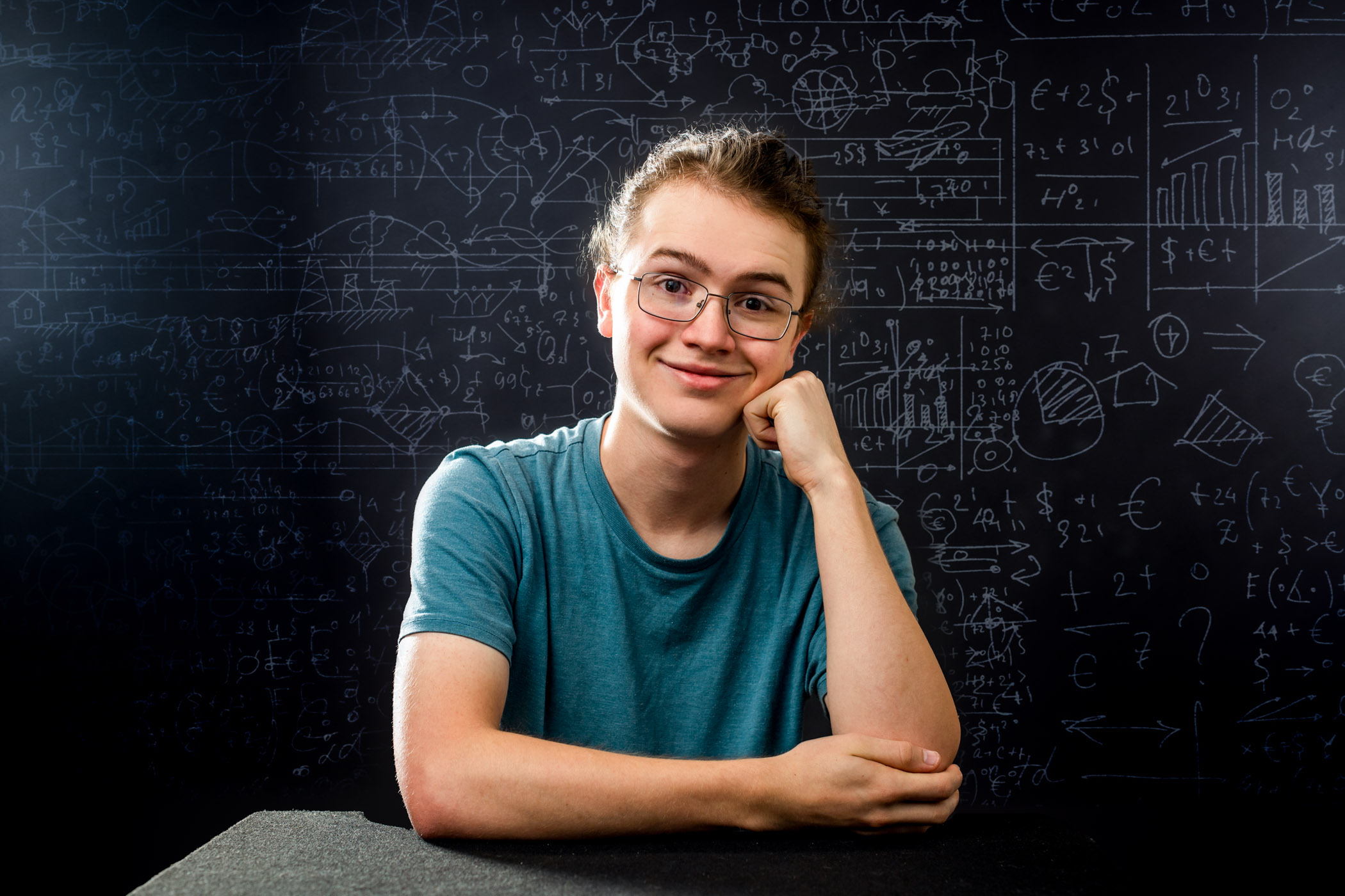Ben Wilson, pictured in front of a board with several math equations