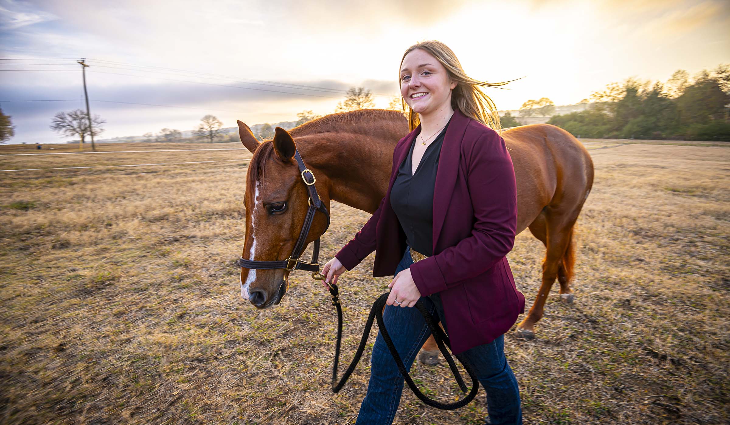 Kasey Losik, pictured walking with a horse on MSU&#039;s South Farm