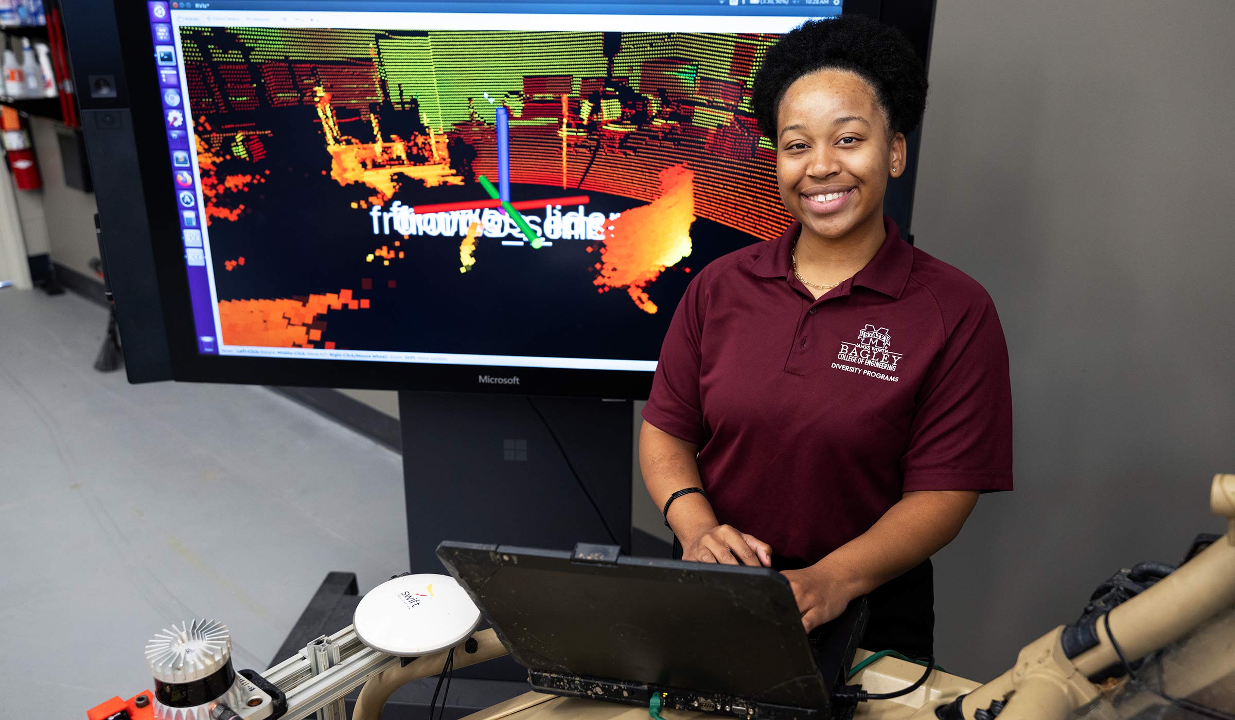 Kennedy Keyes, pictured in front of a screen with digital simulations