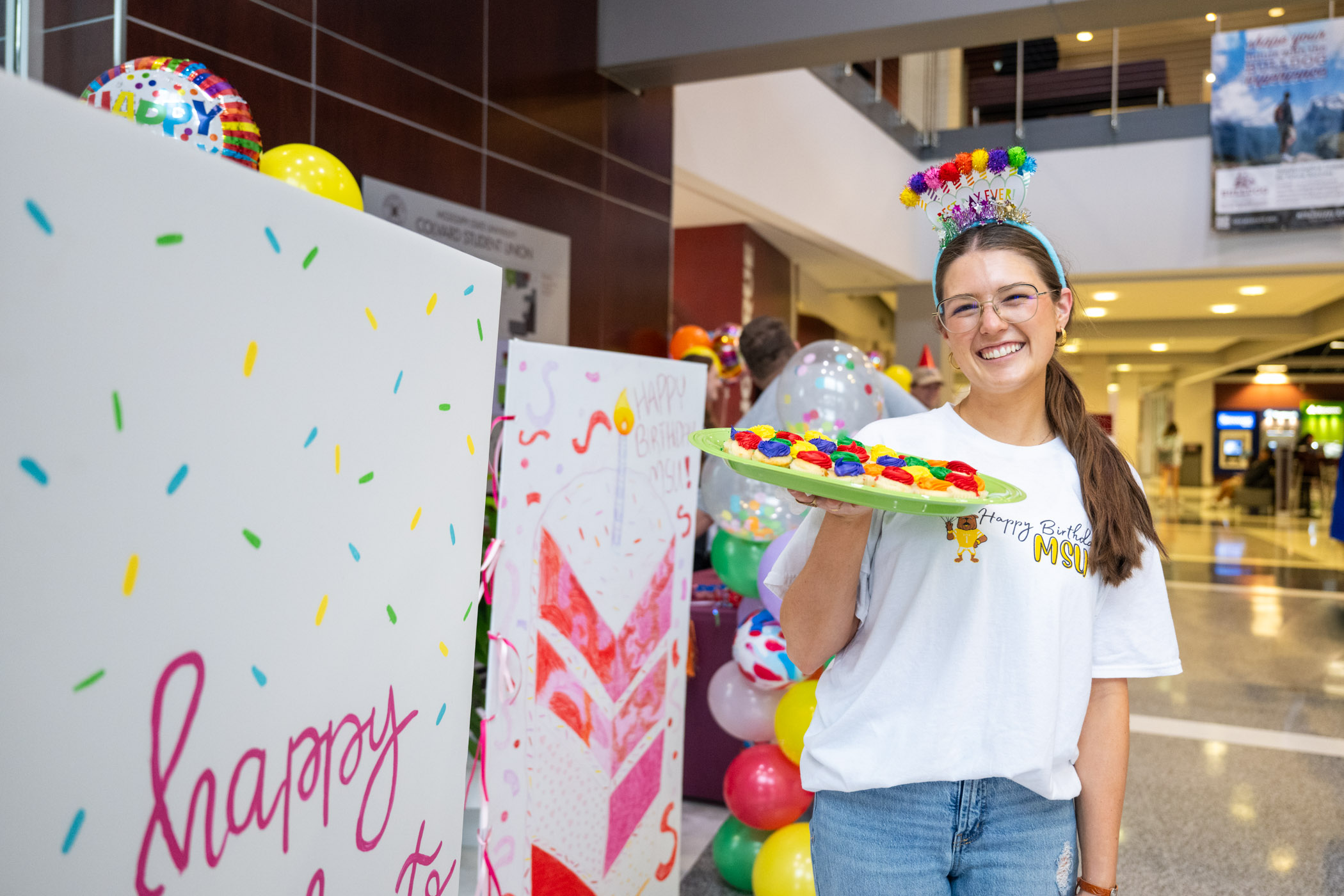 MSU Student Association Director of Programming, Fisher Iseminger , celebrating MSU’s 146th birthday by passing out cupcakes in the Student Union.