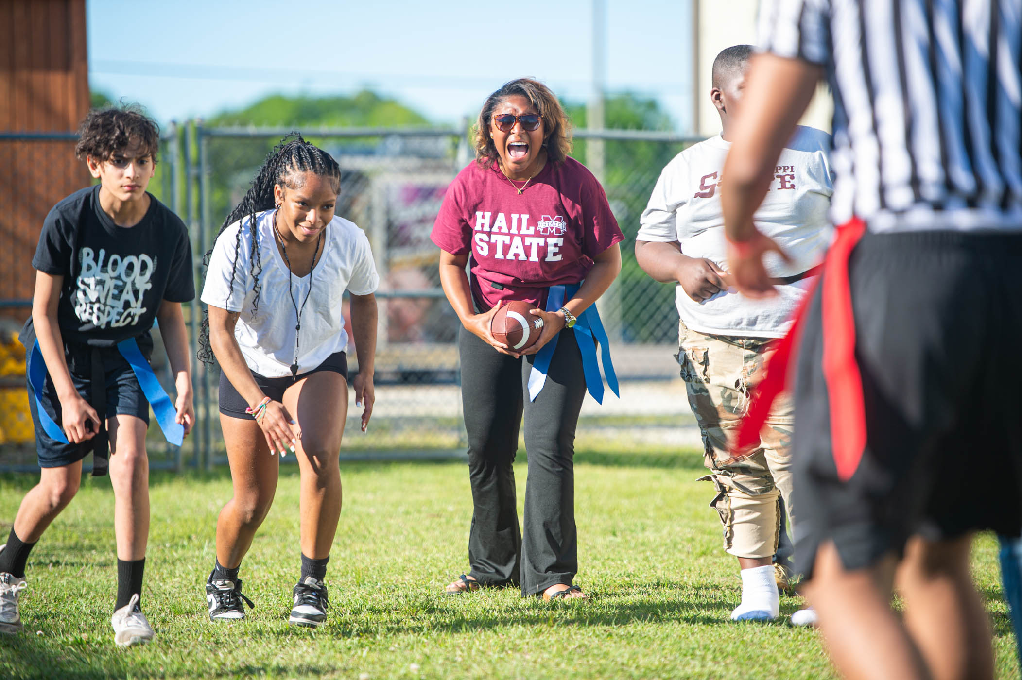 Students in MSU’s Montgomery Leadership Program play a game of flag football with youth at the Boys &amp; Girls Club of the Golden Triangle