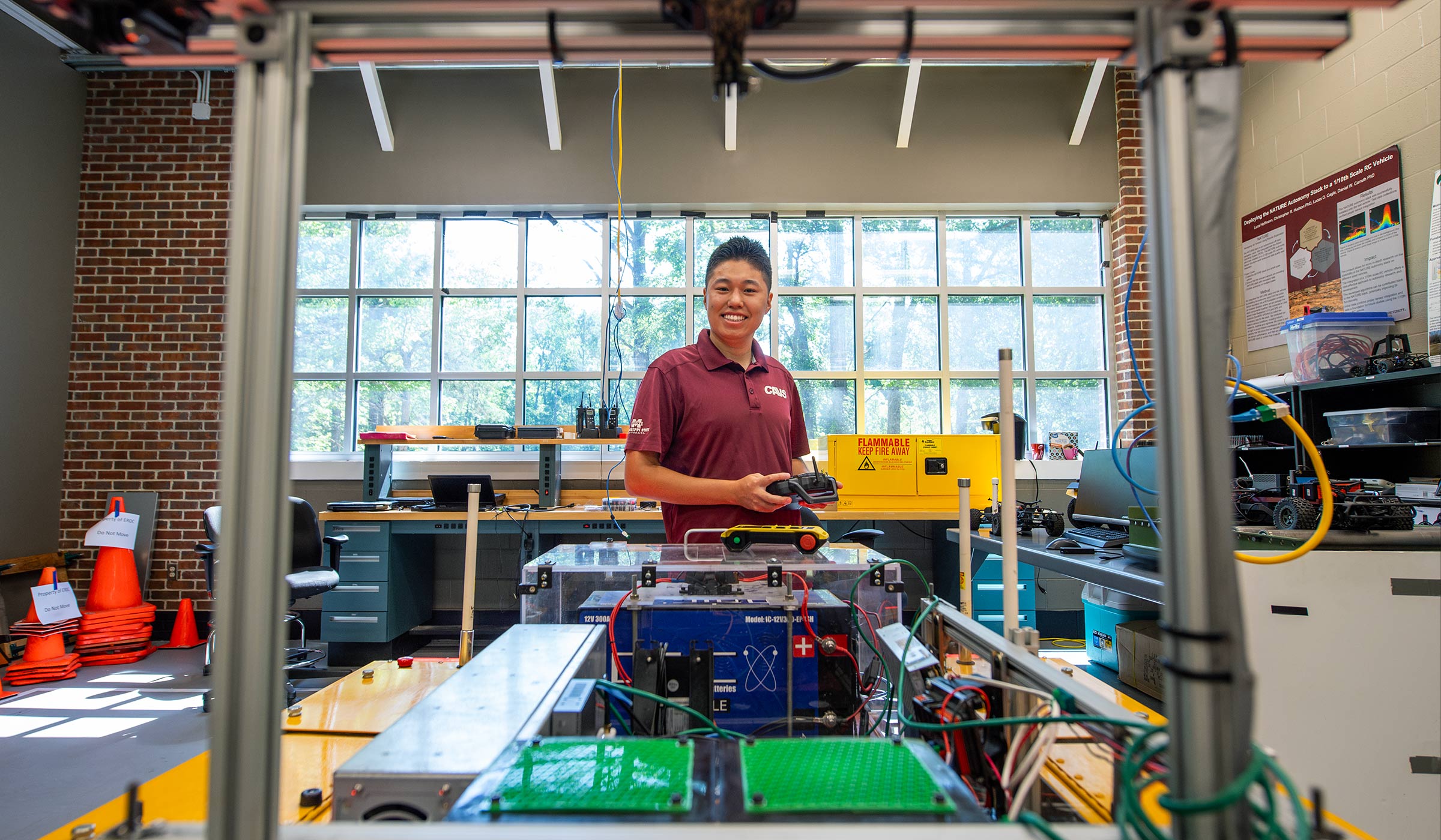 man standing behind a robot