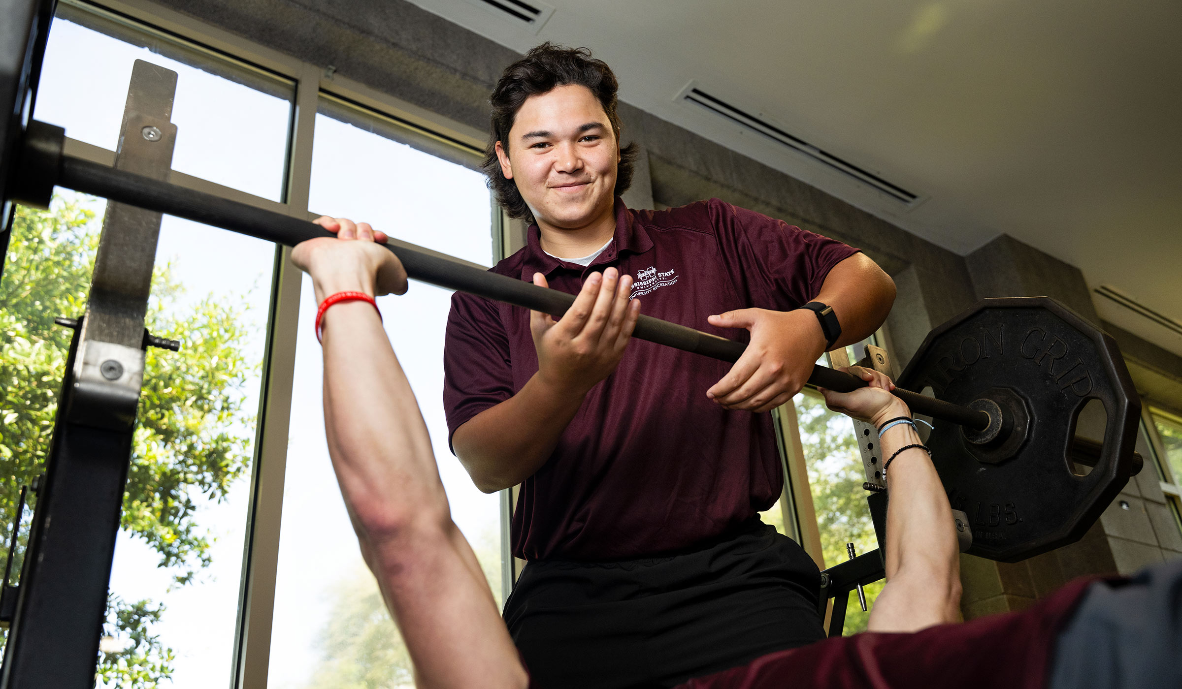 young man lifting barbell