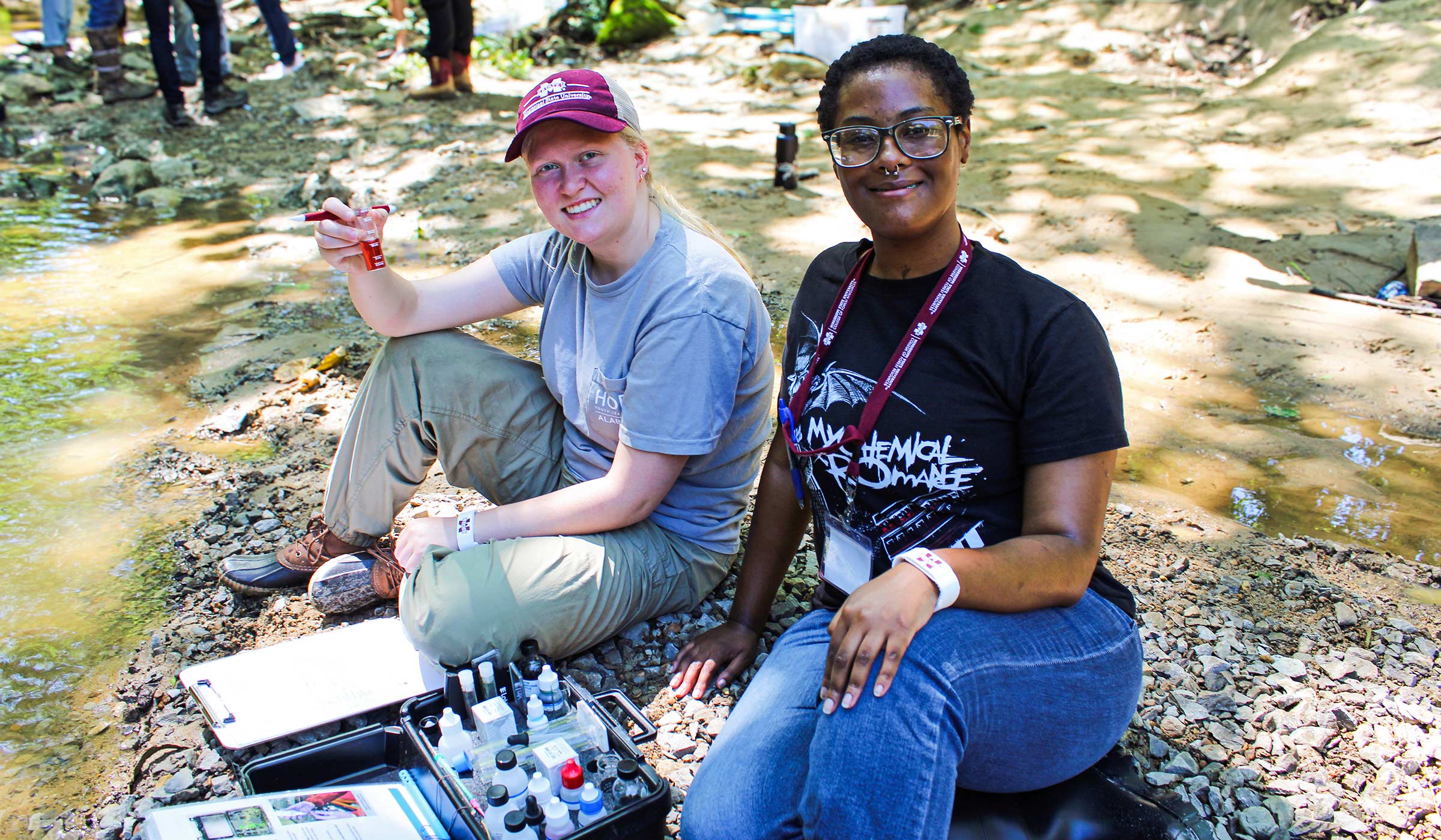 Incoming freshmen sample creek water during Acorn Academy&#039;s environmental stewardship course.