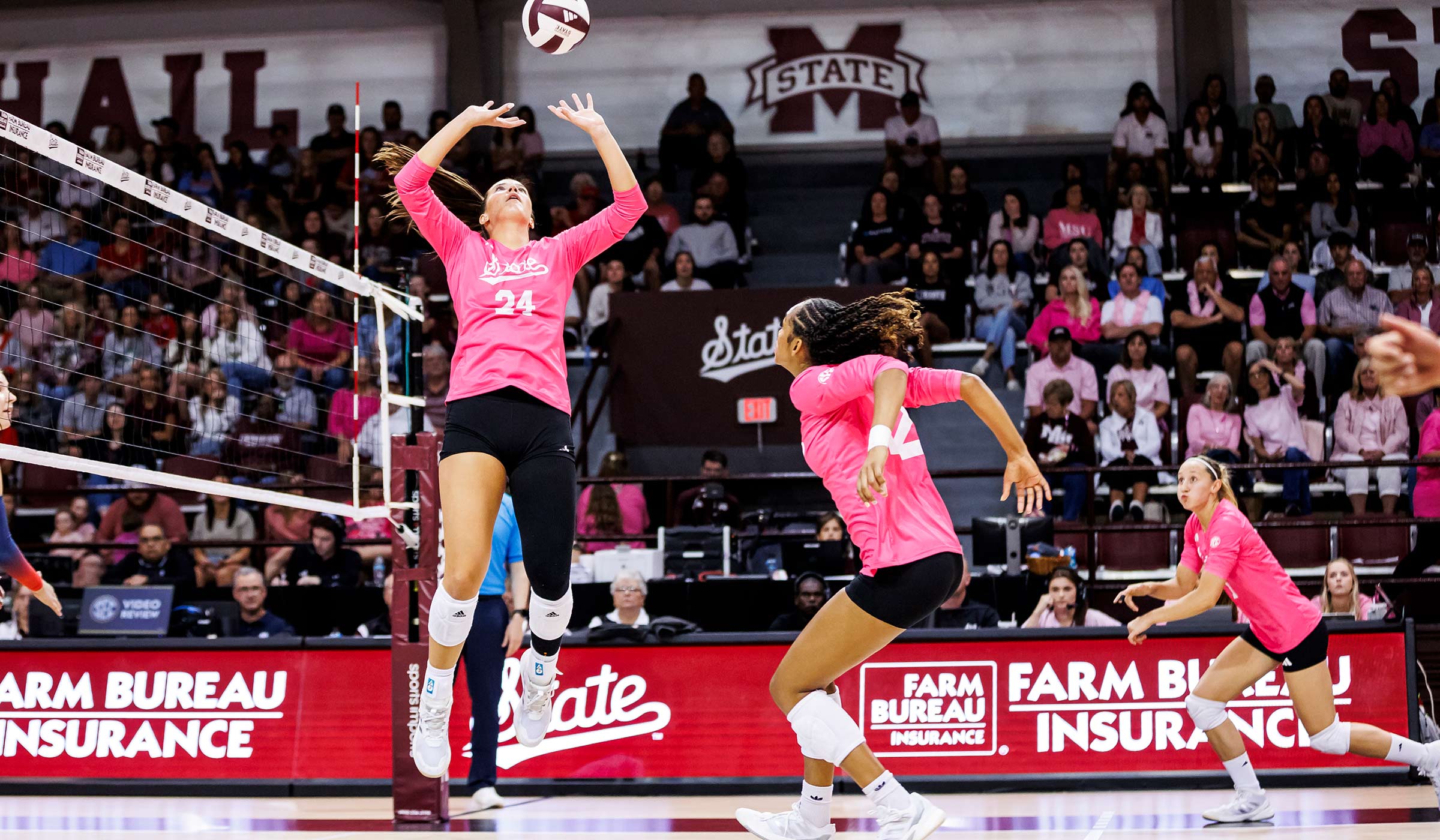 pink volleyball player jumping