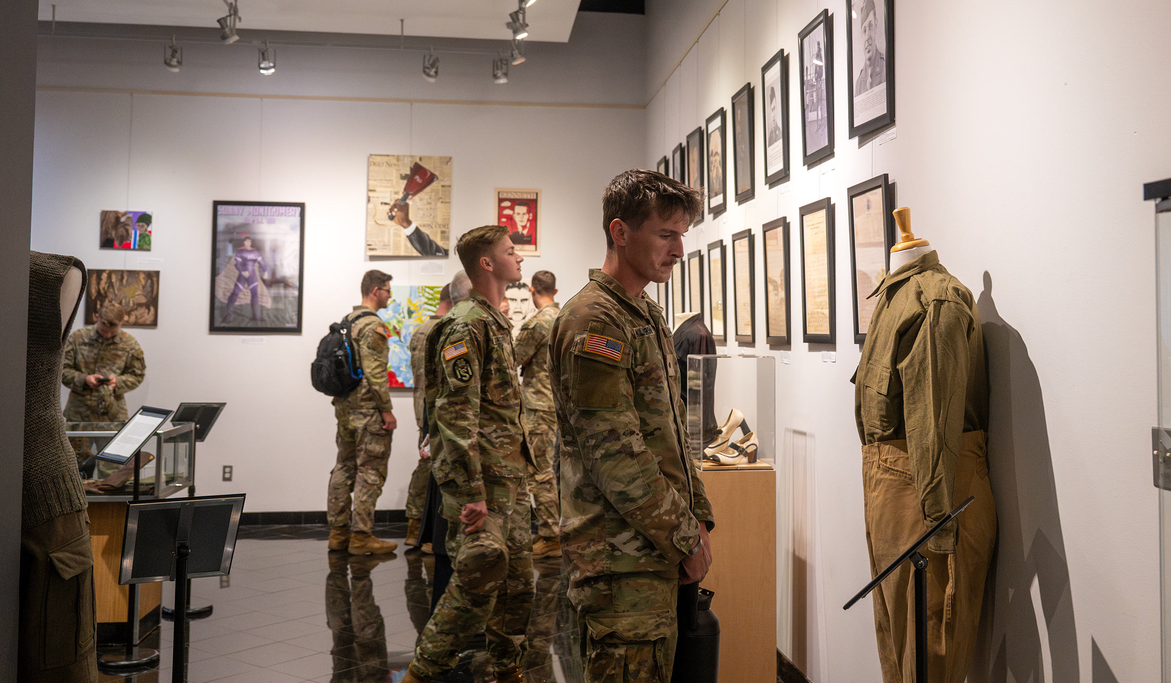 Army ROTC students observe an art display as part of the Veterans Day Ceremony