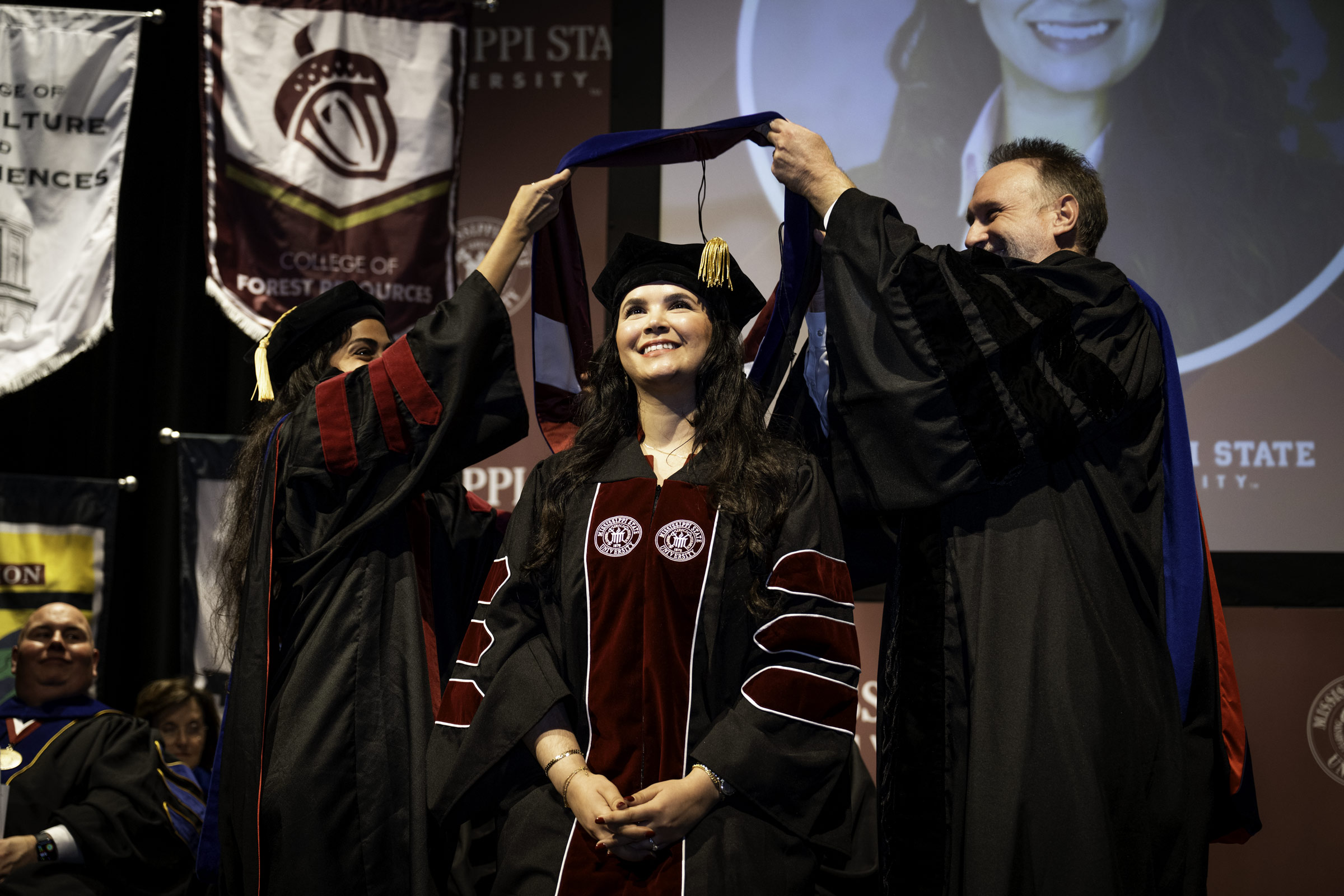 Lamiae Taoudi, a PhD candidate of MSU&#039;s Bagley College of Engineering, is hooded by Dean Dr. David Ford (right) and Dr. Nazanin Tajik (left) at the fall 2025 Doctoral Commencement Ceremony on Thursday, [Dec 11.] The hooding ceremony is one of three commencement events happening at the Starkville campus, with two ceremonies on Friday [Dec. 12]—9:30 a.m. and 2:30 p.m.—in Humphrey Coliseum.   