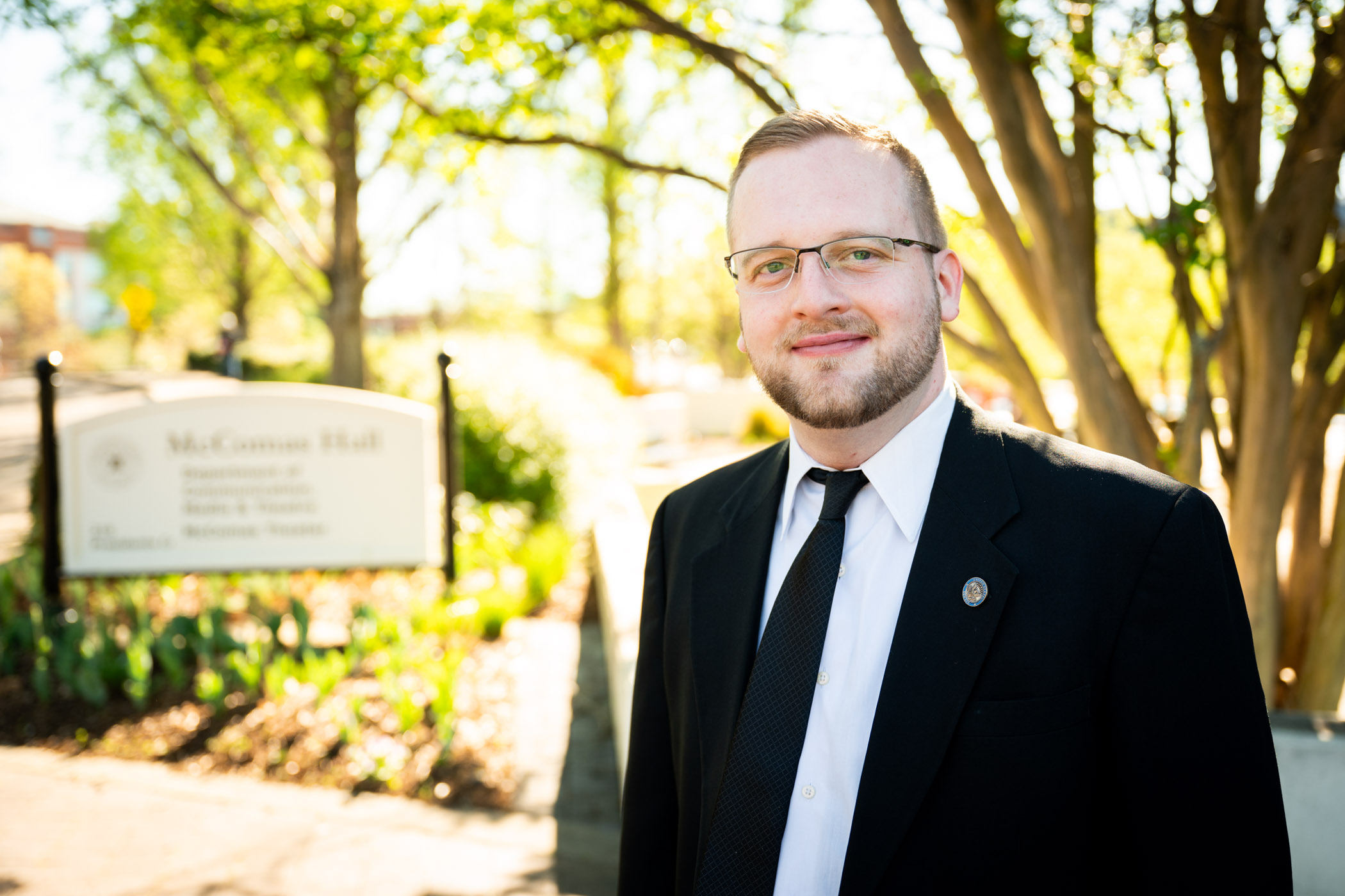 Gil Carter standing in front of a sign