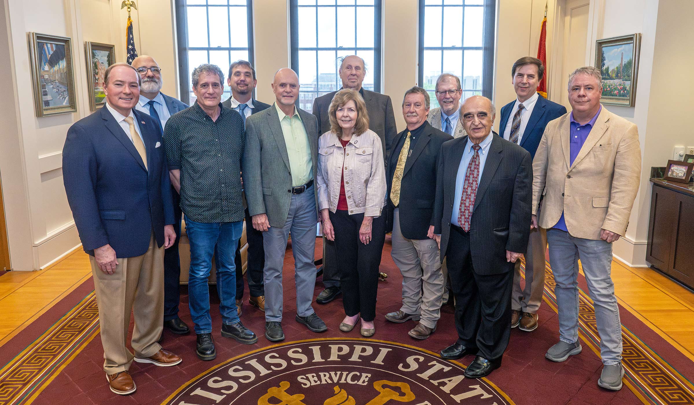 A group of Giles professors stand with Dr. Keenum in his office for a group photo.