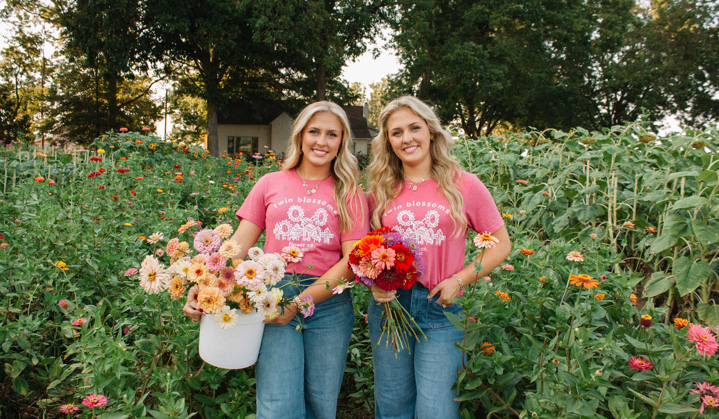 Photo of twin girls in a field with a floral arrangement