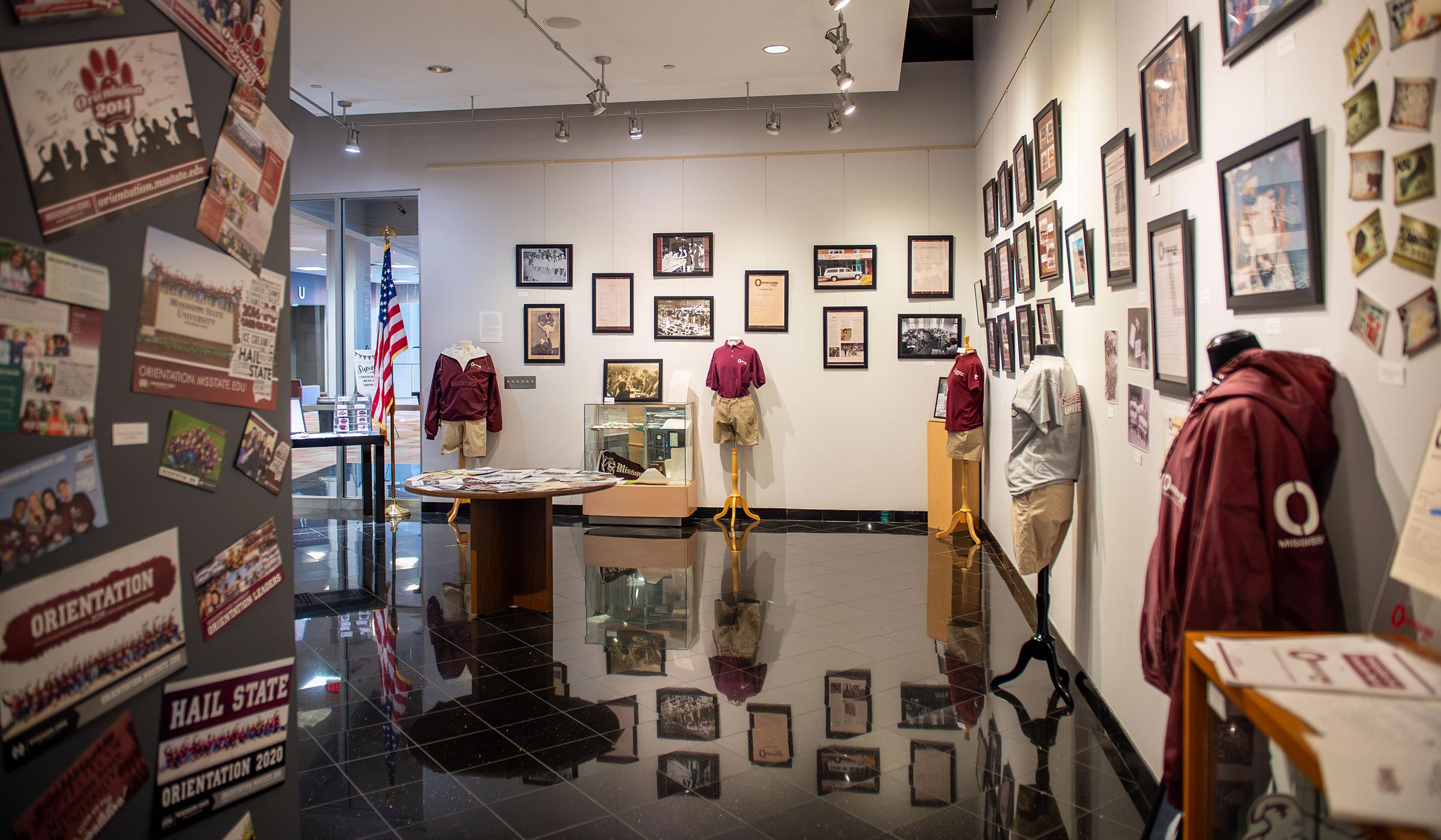 A display in the Union gallery featuring clothing, photos, posters and other items to commemorate 100 years of orientation.